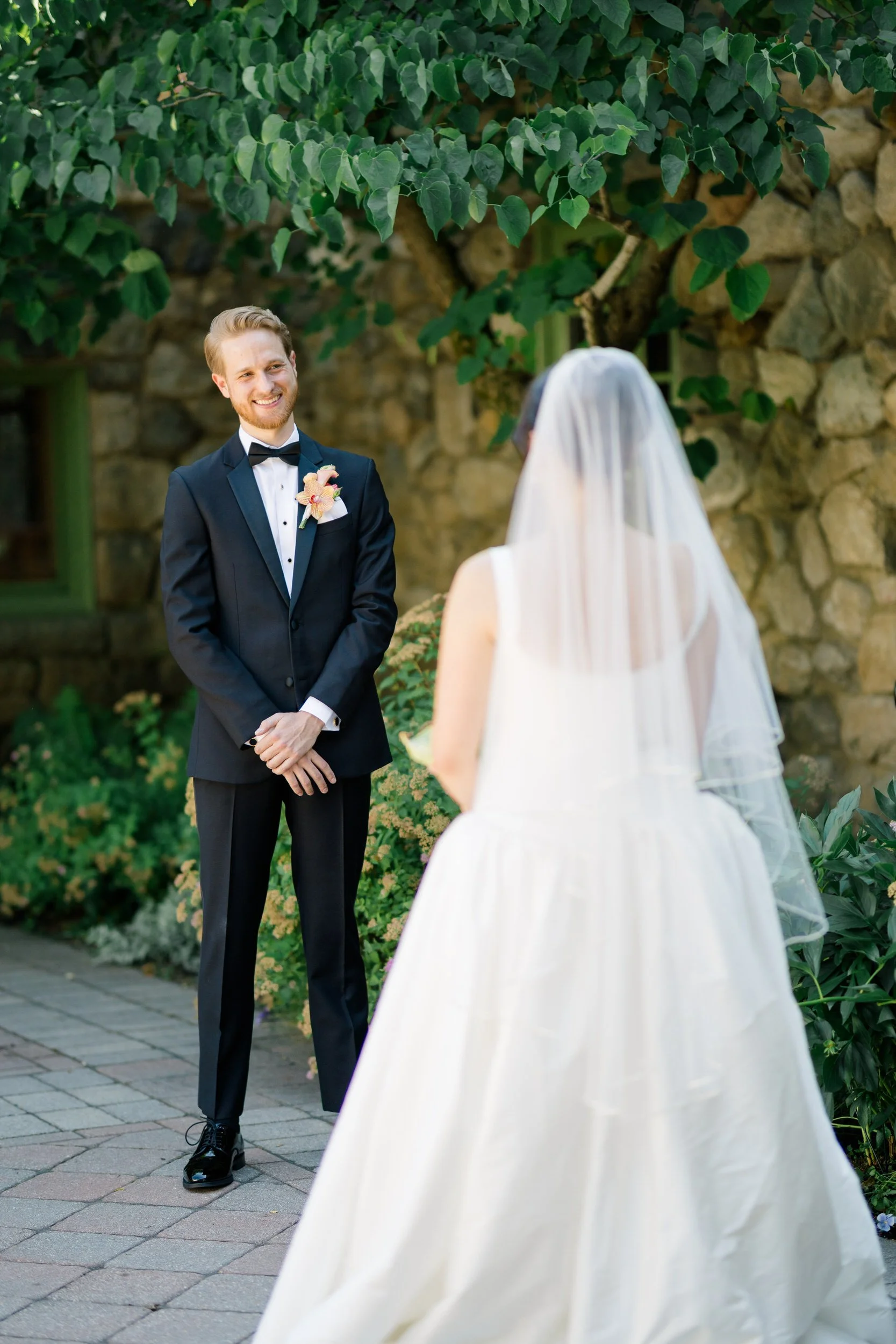 Couple seeing each other for the first time during colorful summer wedding at Willowdale Estate