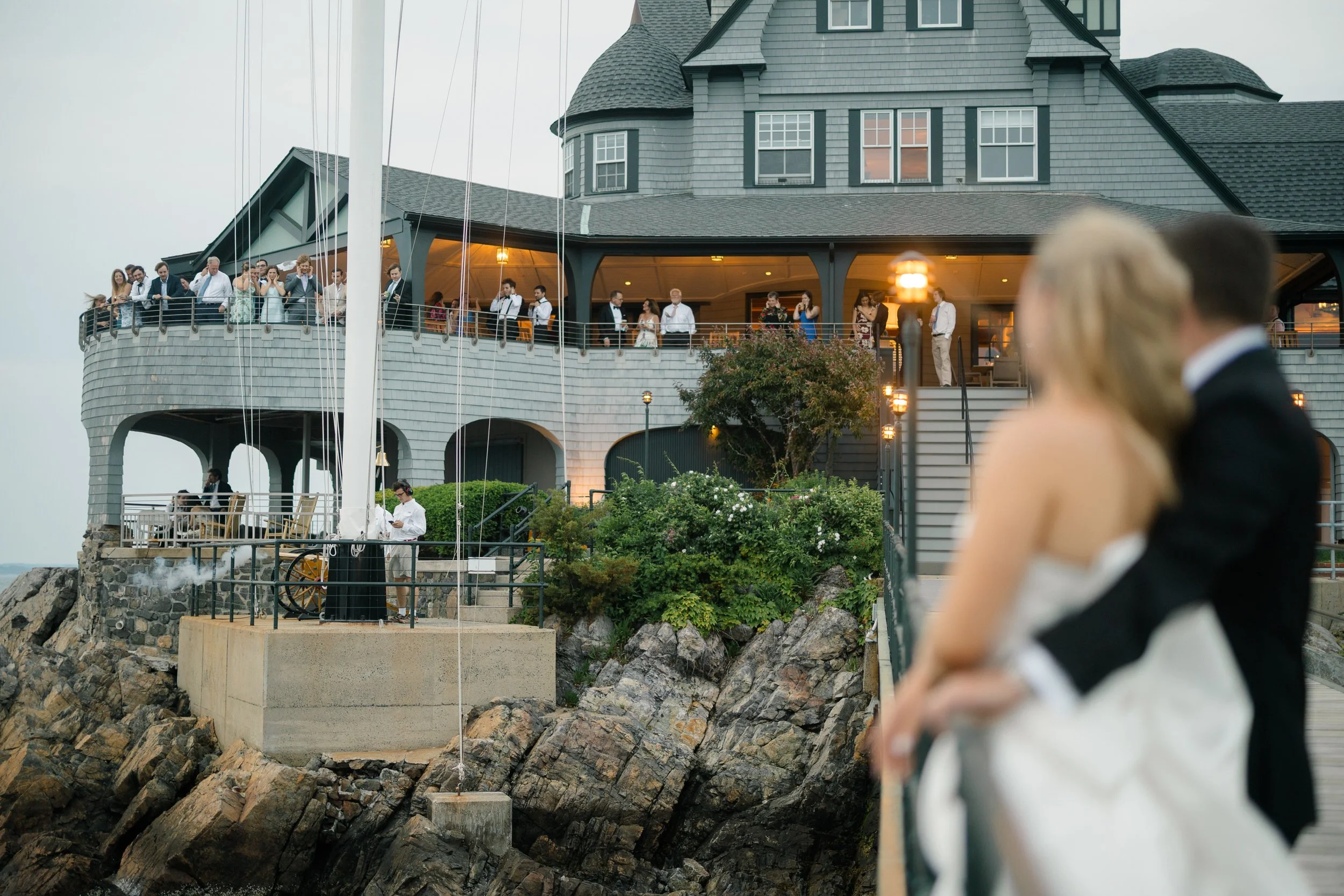 Sunset wedding portraits on the dock at Corinthian Yacht Club overlooking Marblehead Harbor.