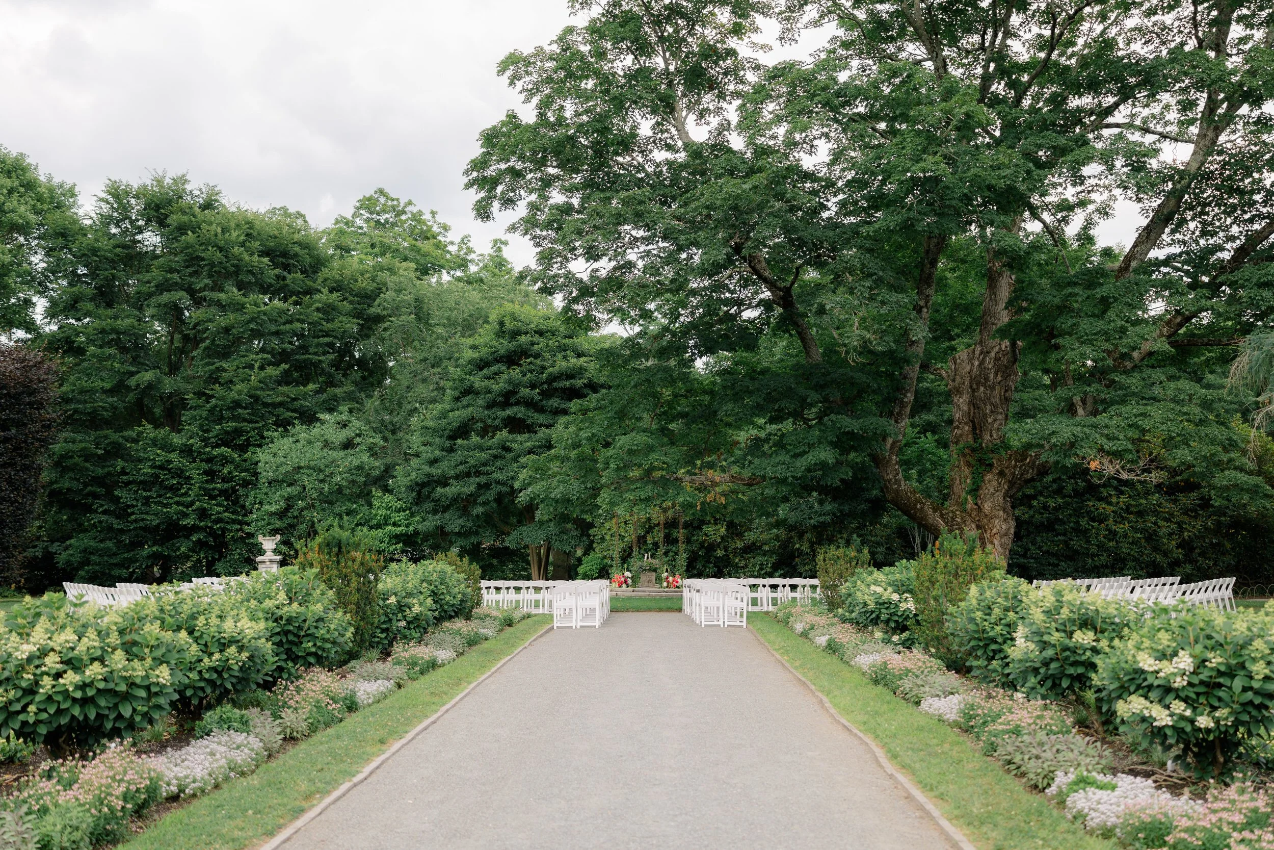 Garden wedding ceremony setup with pink and green florals at Elm Bank