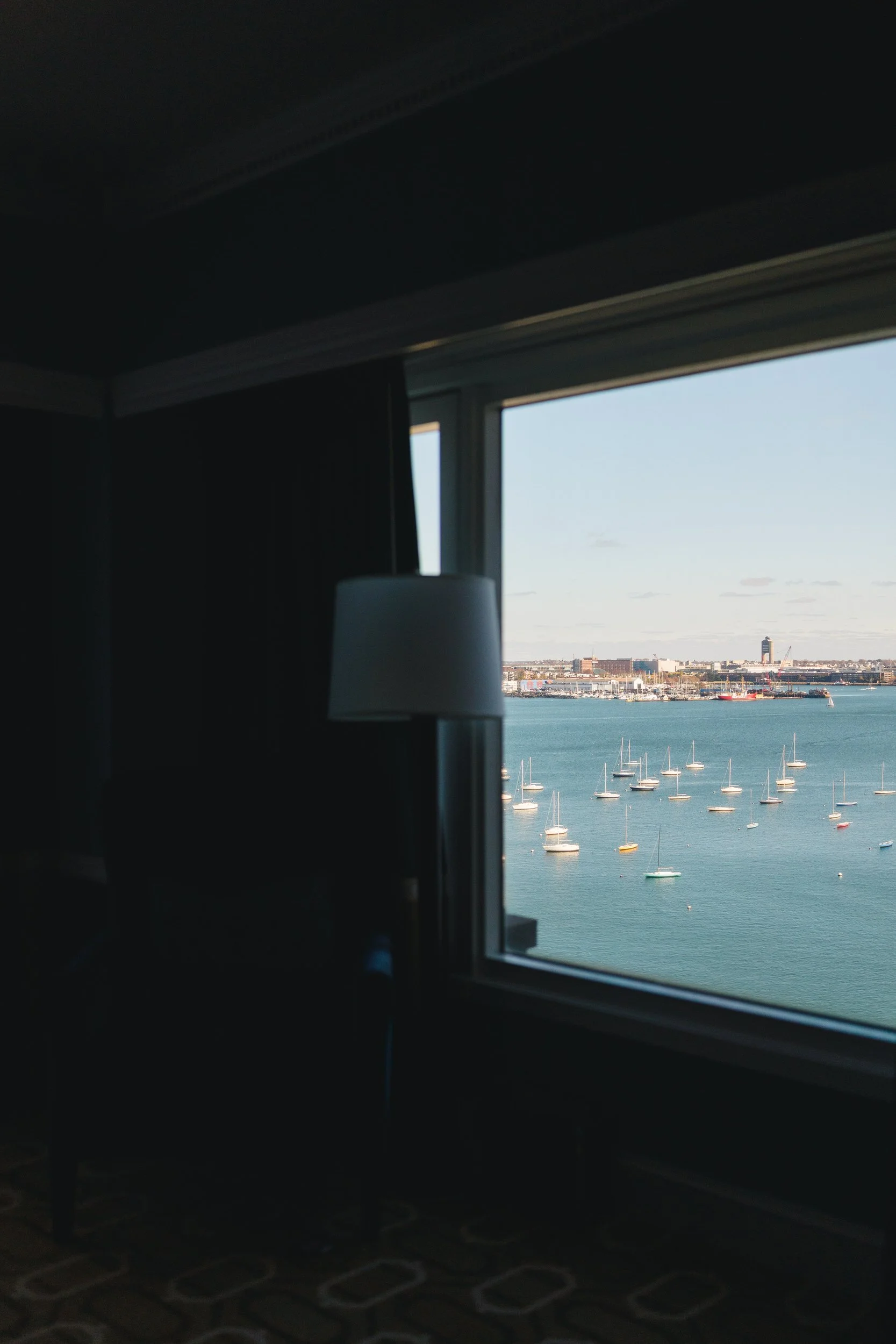 Soft window light illuminating the bride during getting ready at the Boston Harbor Hotel