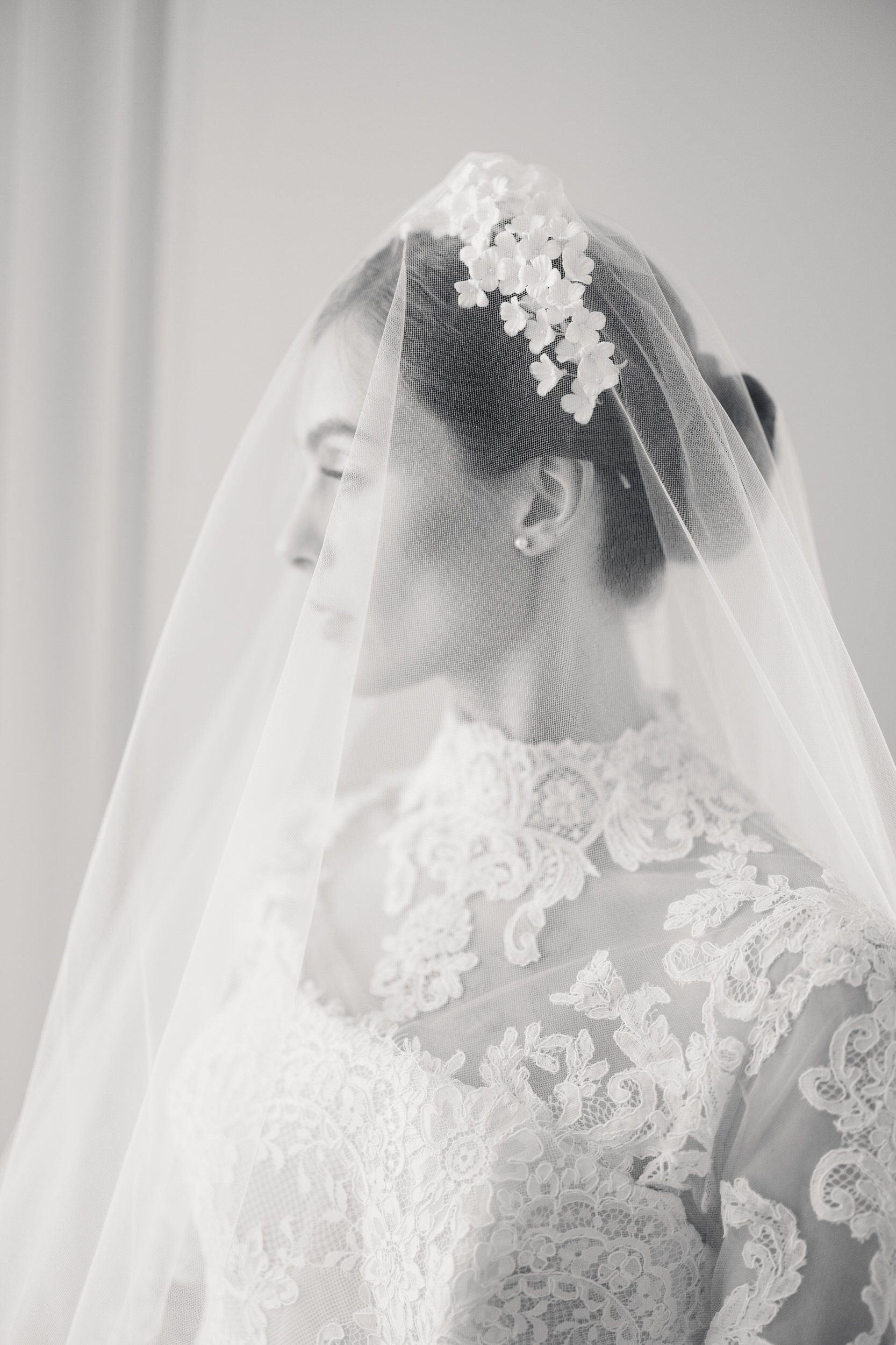 Bride in a chic neutral gown standing inside Brasserie La Banque, Charleston, SC, photographed by a Charleston wedding photographer for editorial portraits