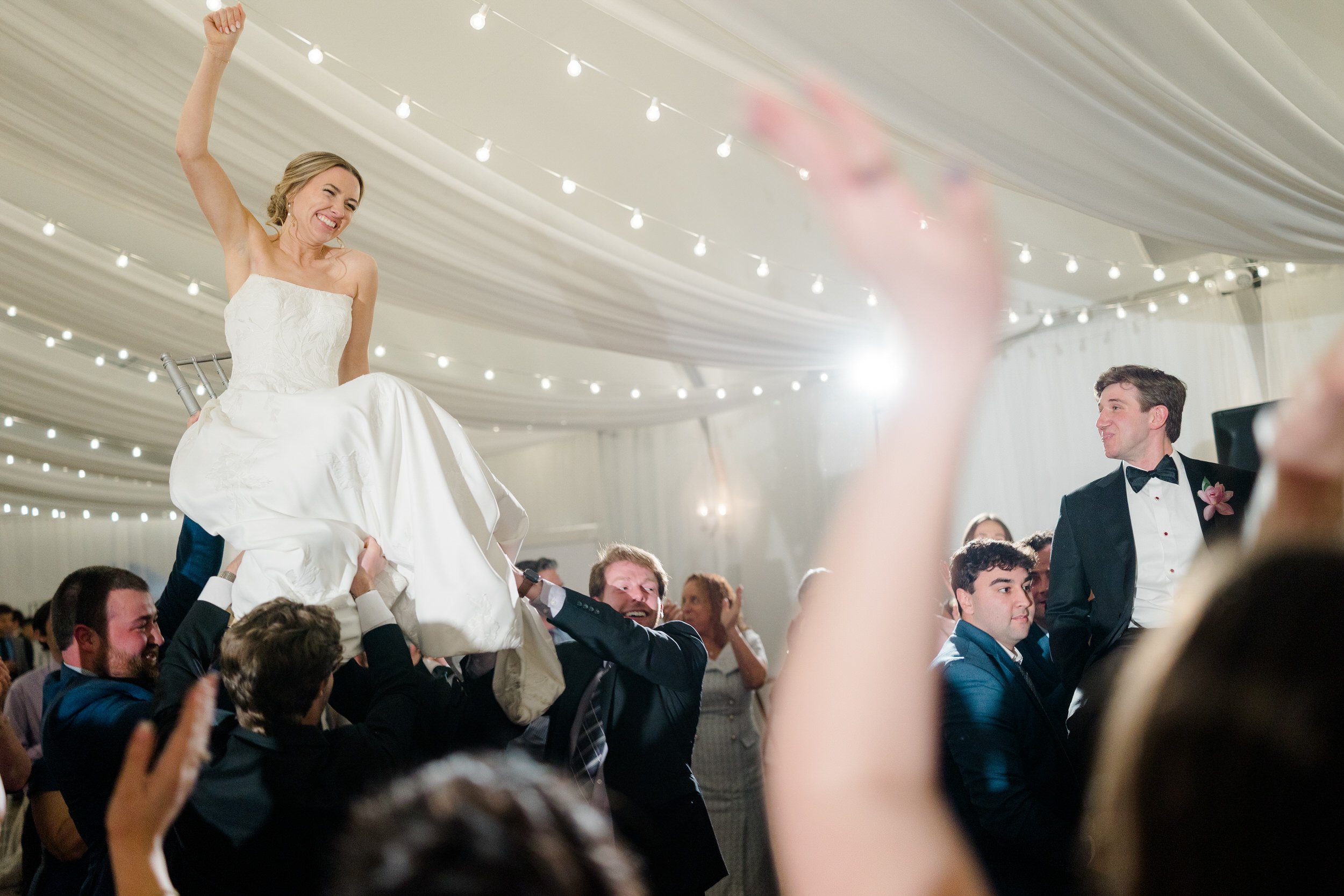 Energetic wedding dancing at modern oceanfront wedding reception