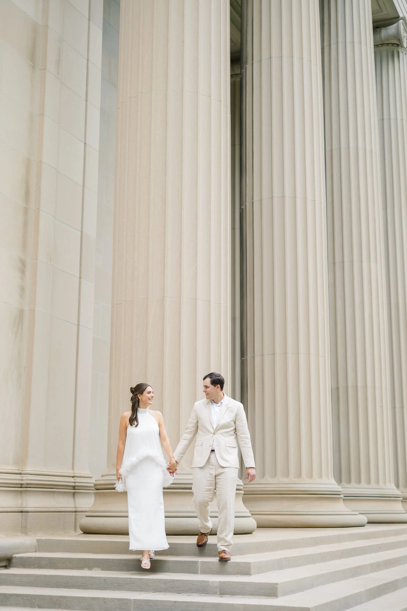 Elegant couple portraits featuring marble columns and timeless Cambridge architecture.