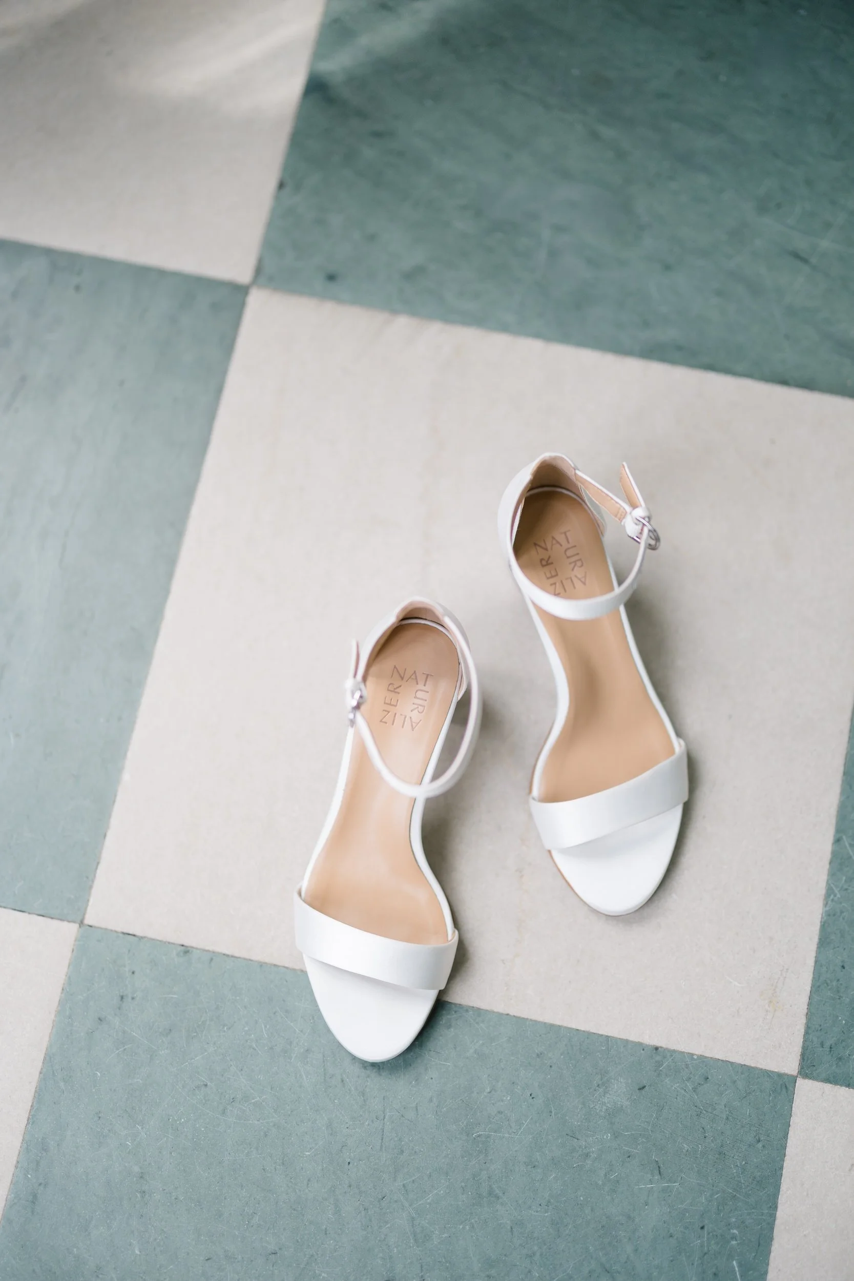 Bride's accessories, jewelry, and stationery photographed with romantic garden-inspired details.