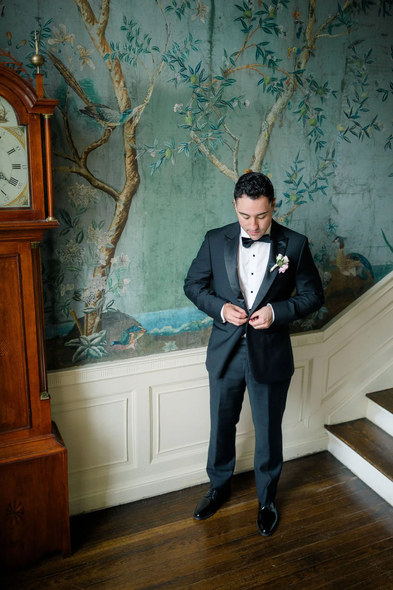 Groom adjusting his jacket before the Long Hill wedding ceremony.