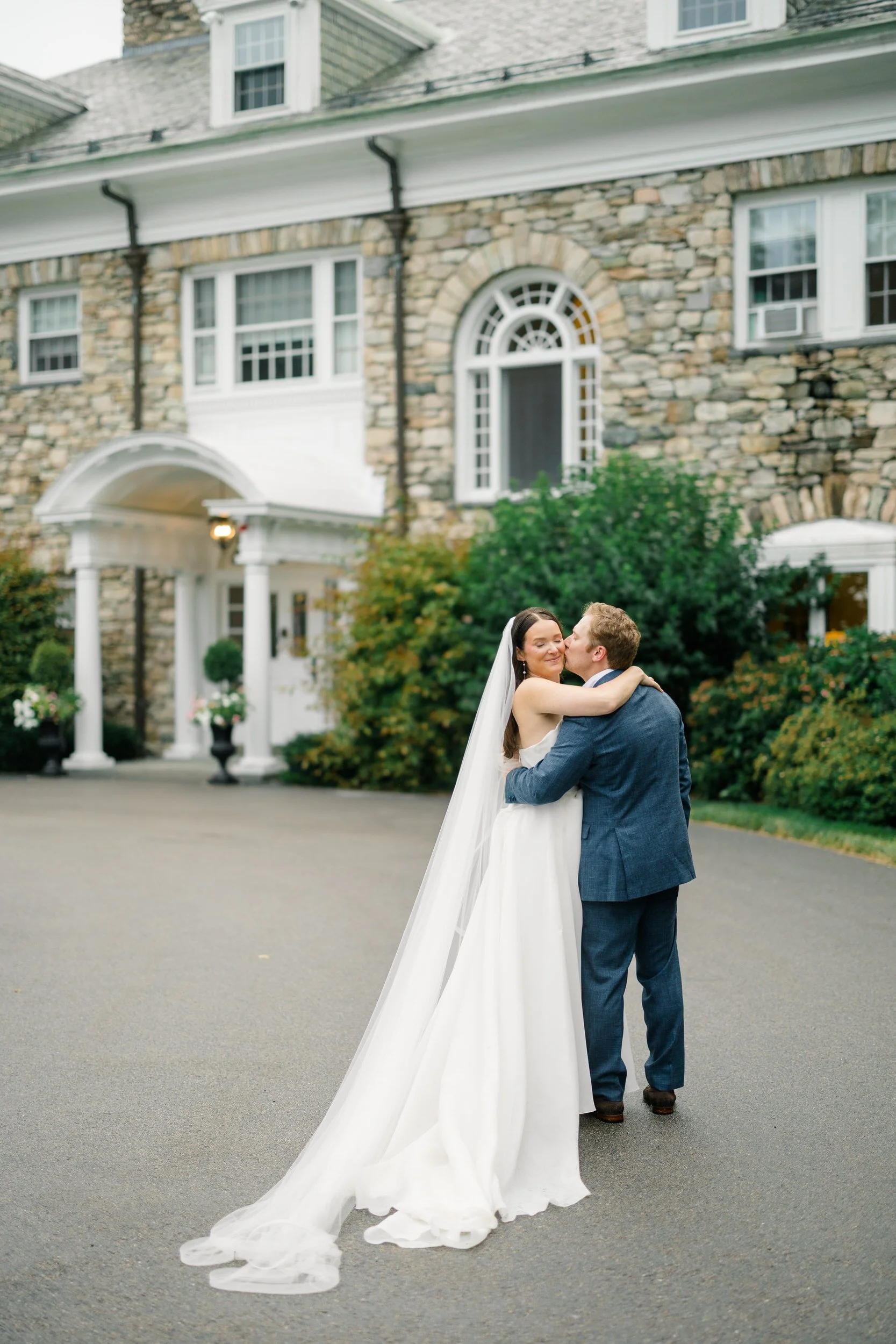 Bride and groom photographed among vibrant seasonal florals at the Connors Center.