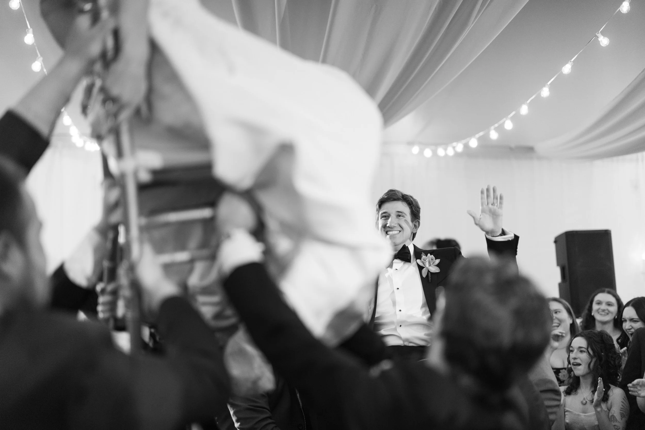Energetic wedding dancing at modern oceanfront wedding reception
