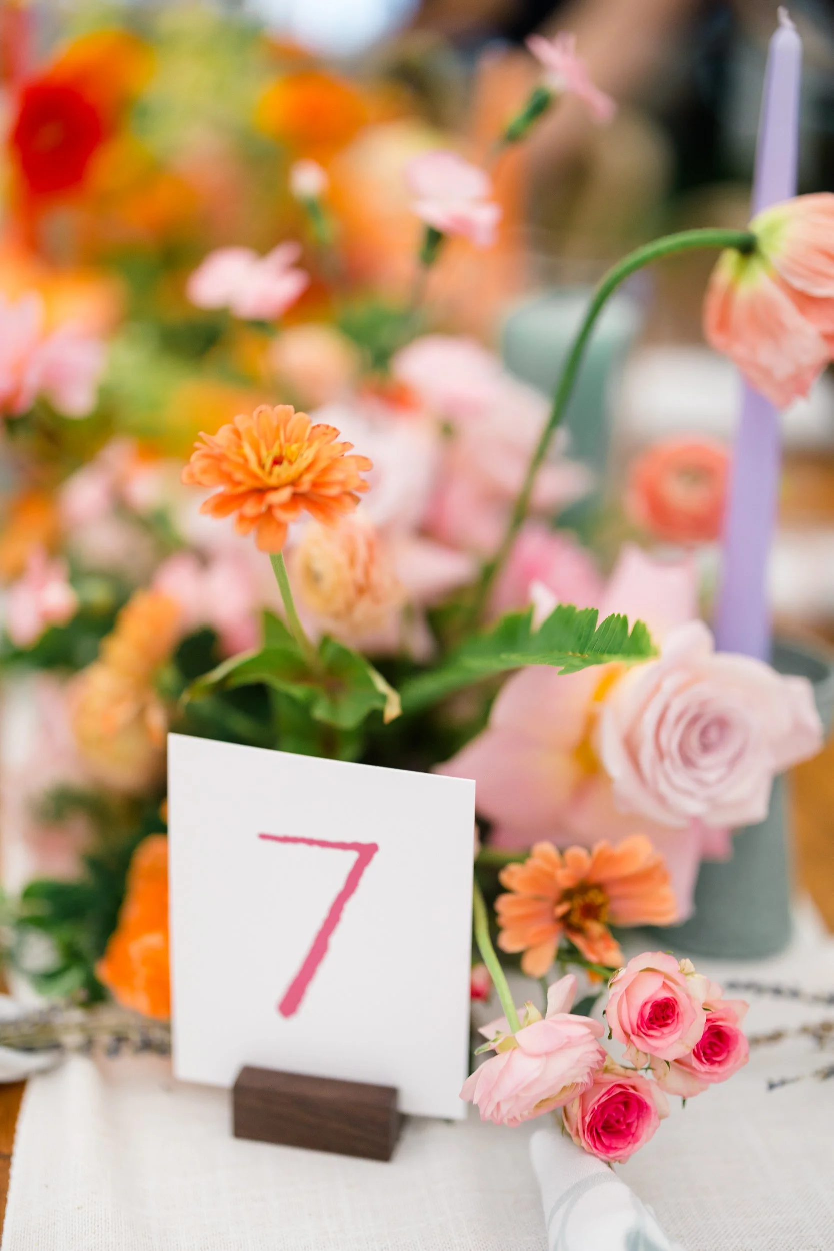 Reception tent transformed into a colorful secret garden with lush seasonal flowers.