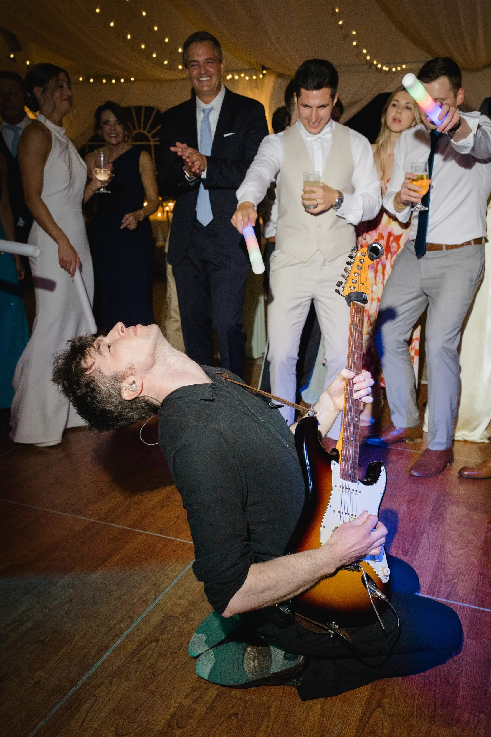 Packed dance floor during an elegant coastal wedding celebration.