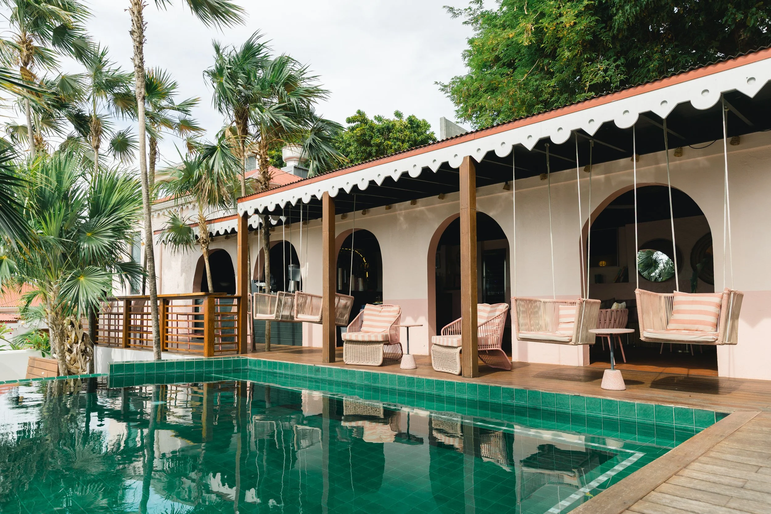The Pink Palm Hotel pool with blue-green tile and views overlooking Charlotte Amalie harbor