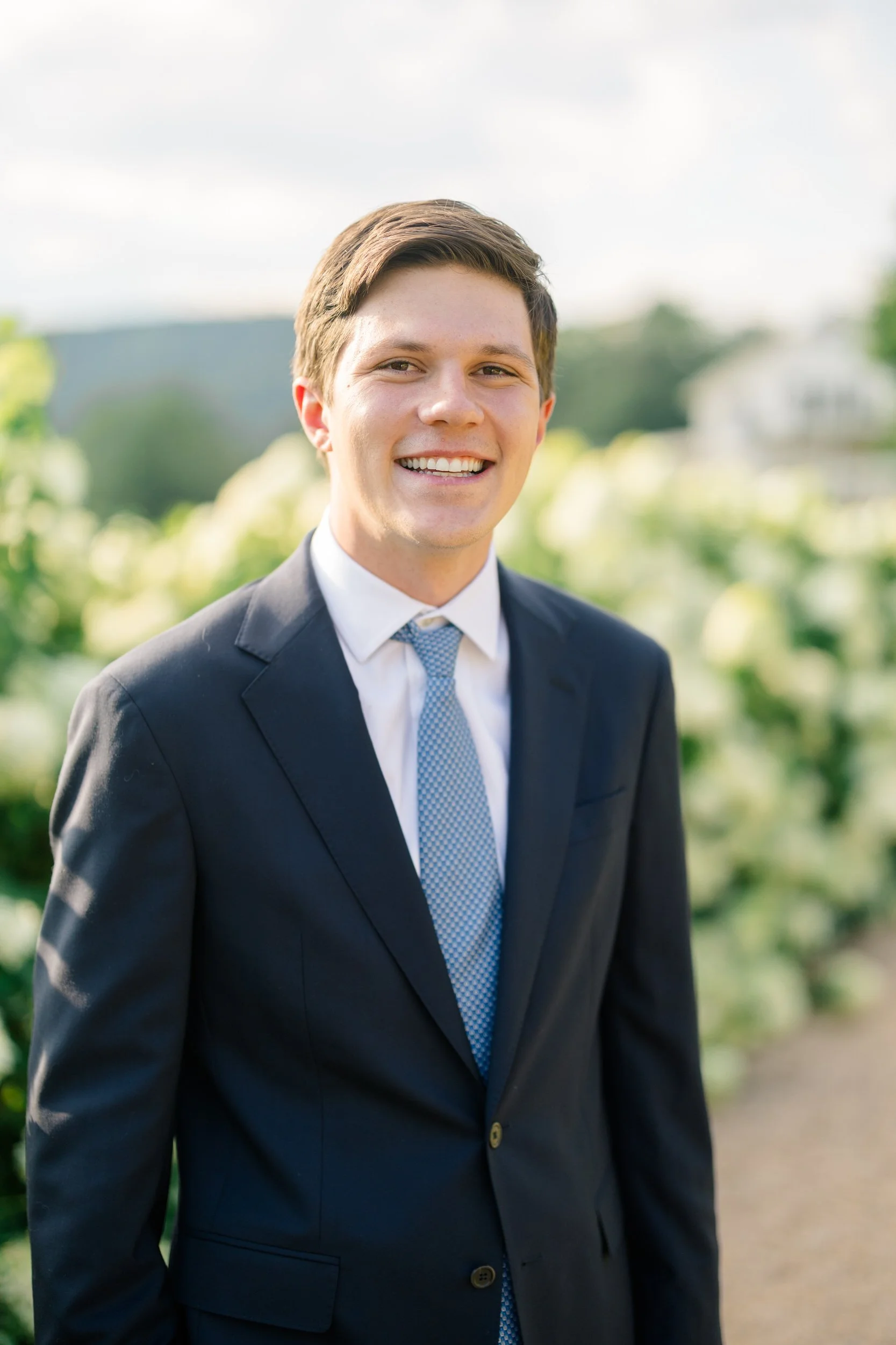 Romantic engagement portraits among the white hydrangeas at Pippin Hill