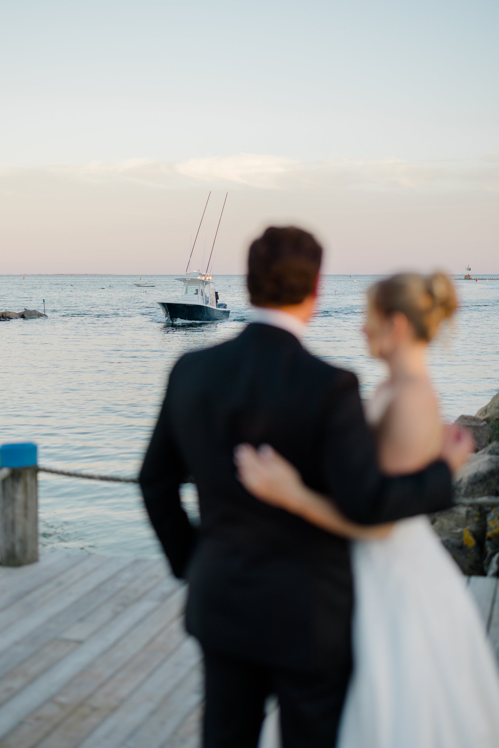 Bride and groom photographed during golden hour overlooking Wychmere Harbor.