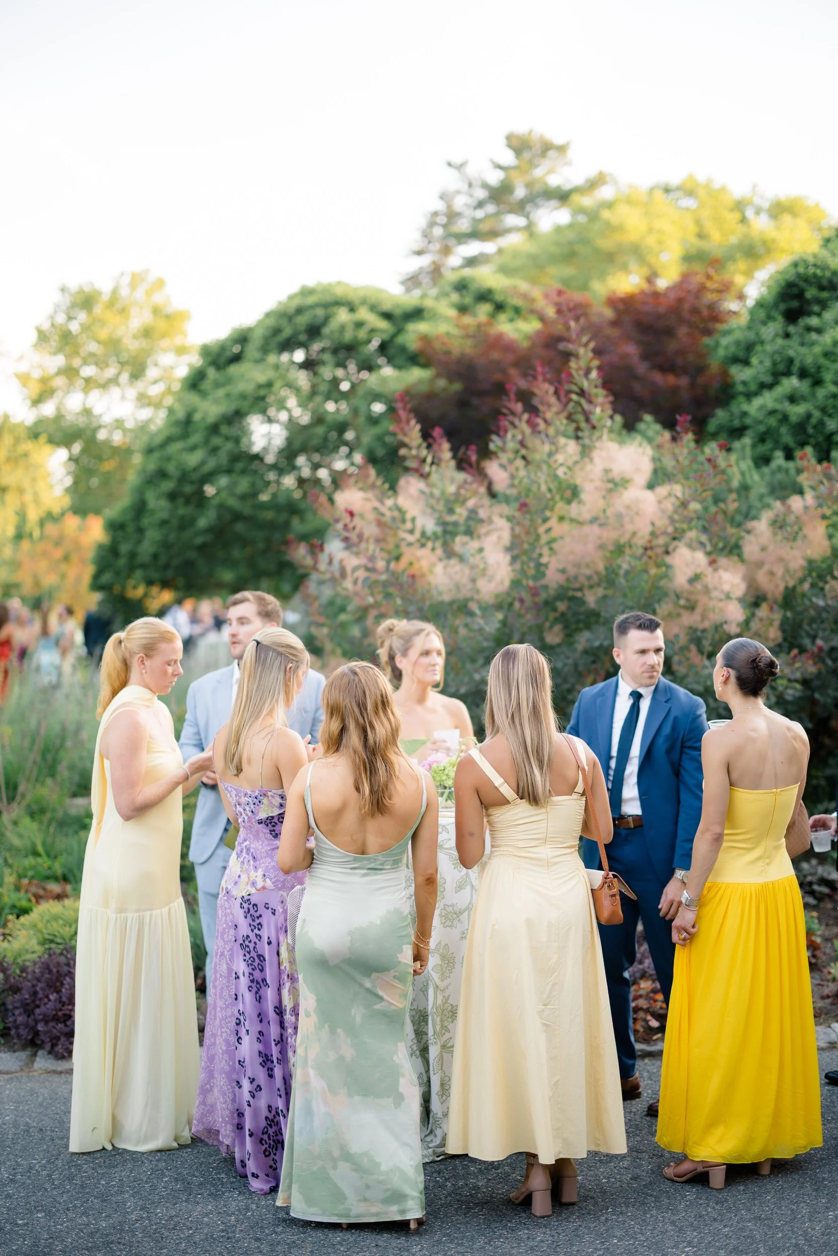 Wedding guests celebrating outdoors during an Elm Bank wedding cocktail hour