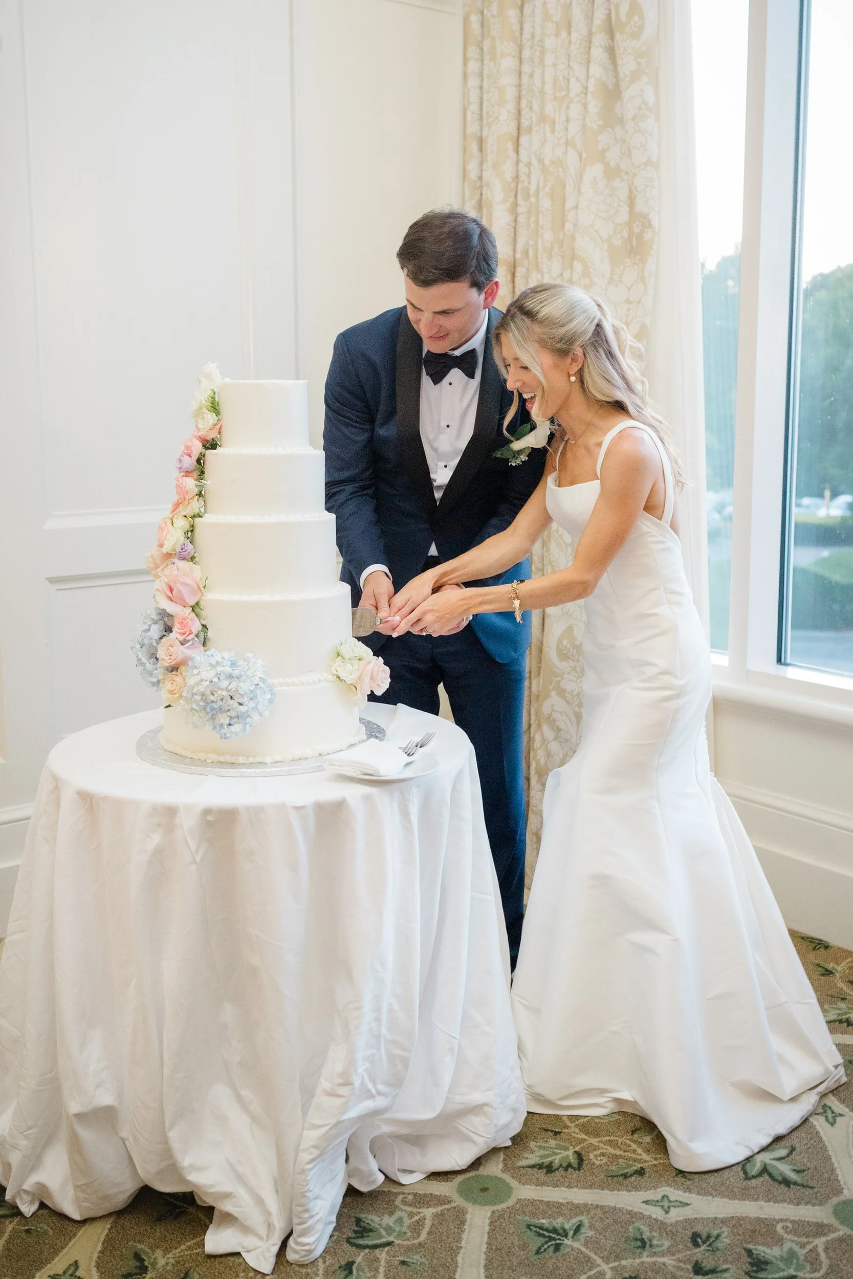 Bride and groom cutting their wedding cake at Ocean Edge Resort
