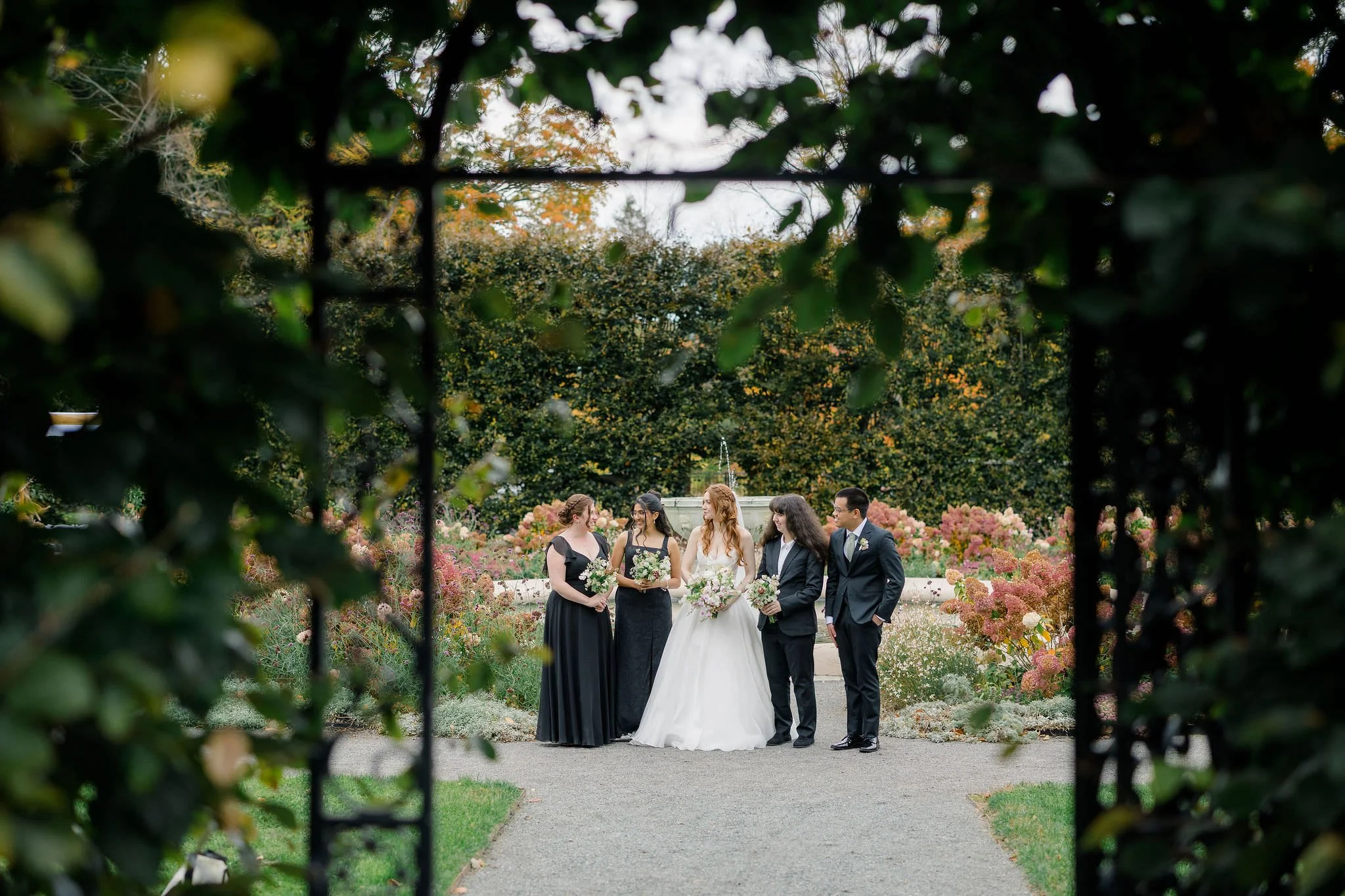 Bridesmaids portraits at a romantic secret garden inspired wedding.