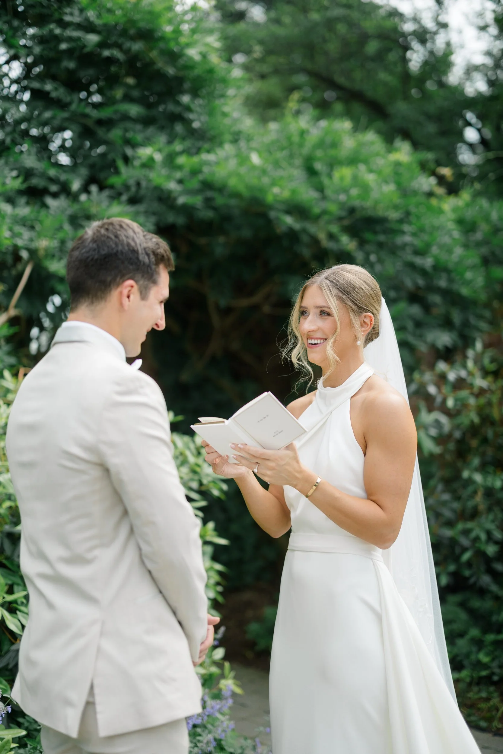 Couple exchanging handwritten vows before their ceremony at Misselwood Estate.