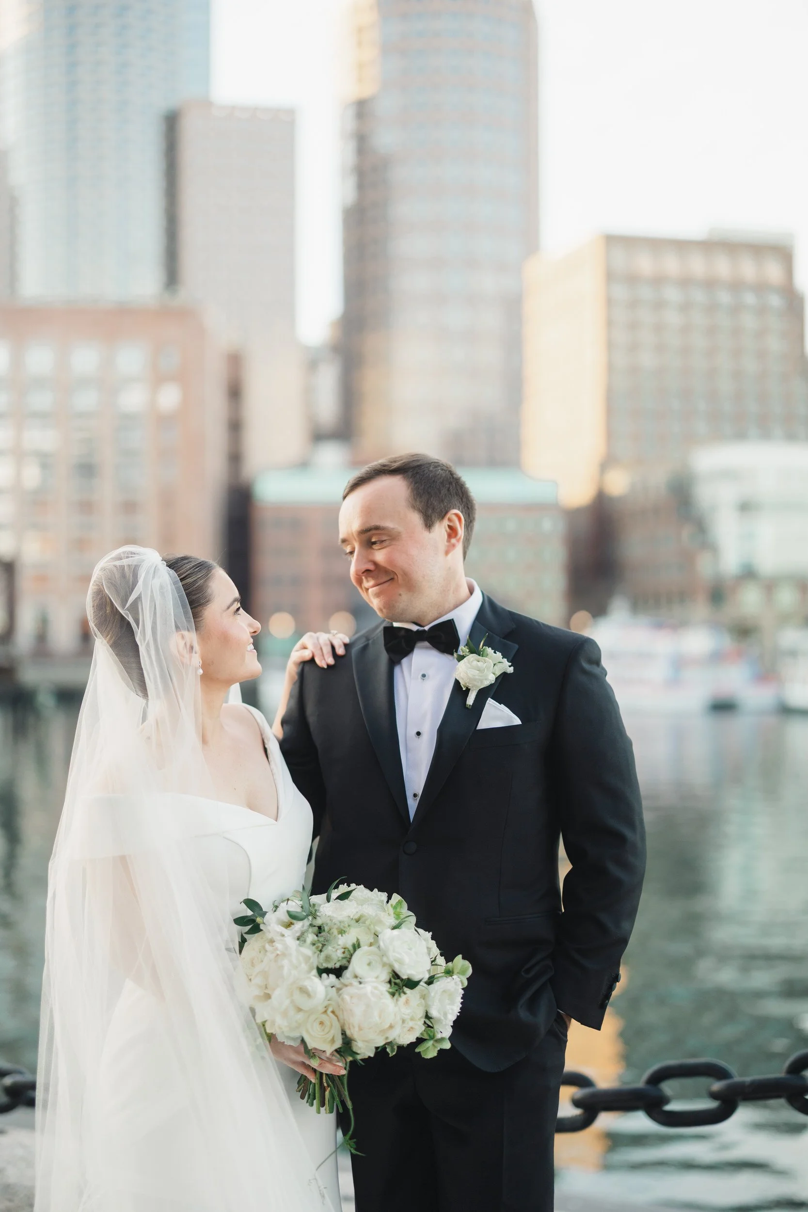 Bride and groom at sunset overlooking Boston Harbor