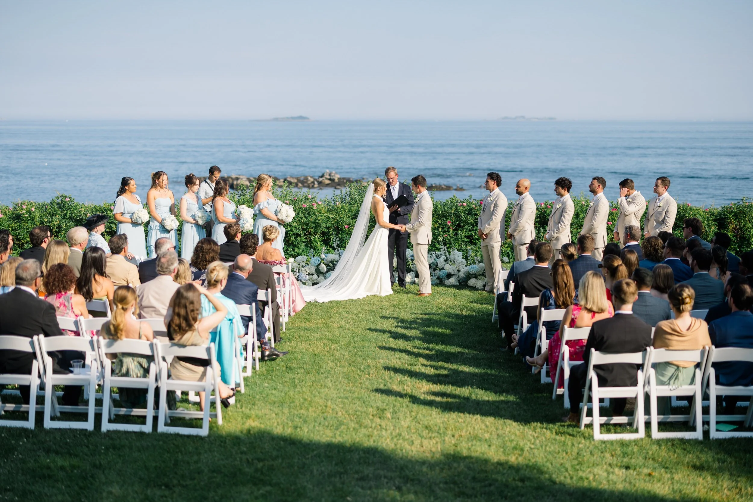 Summer wedding ceremony overlooking the ocean in Beverly, Massachusetts.