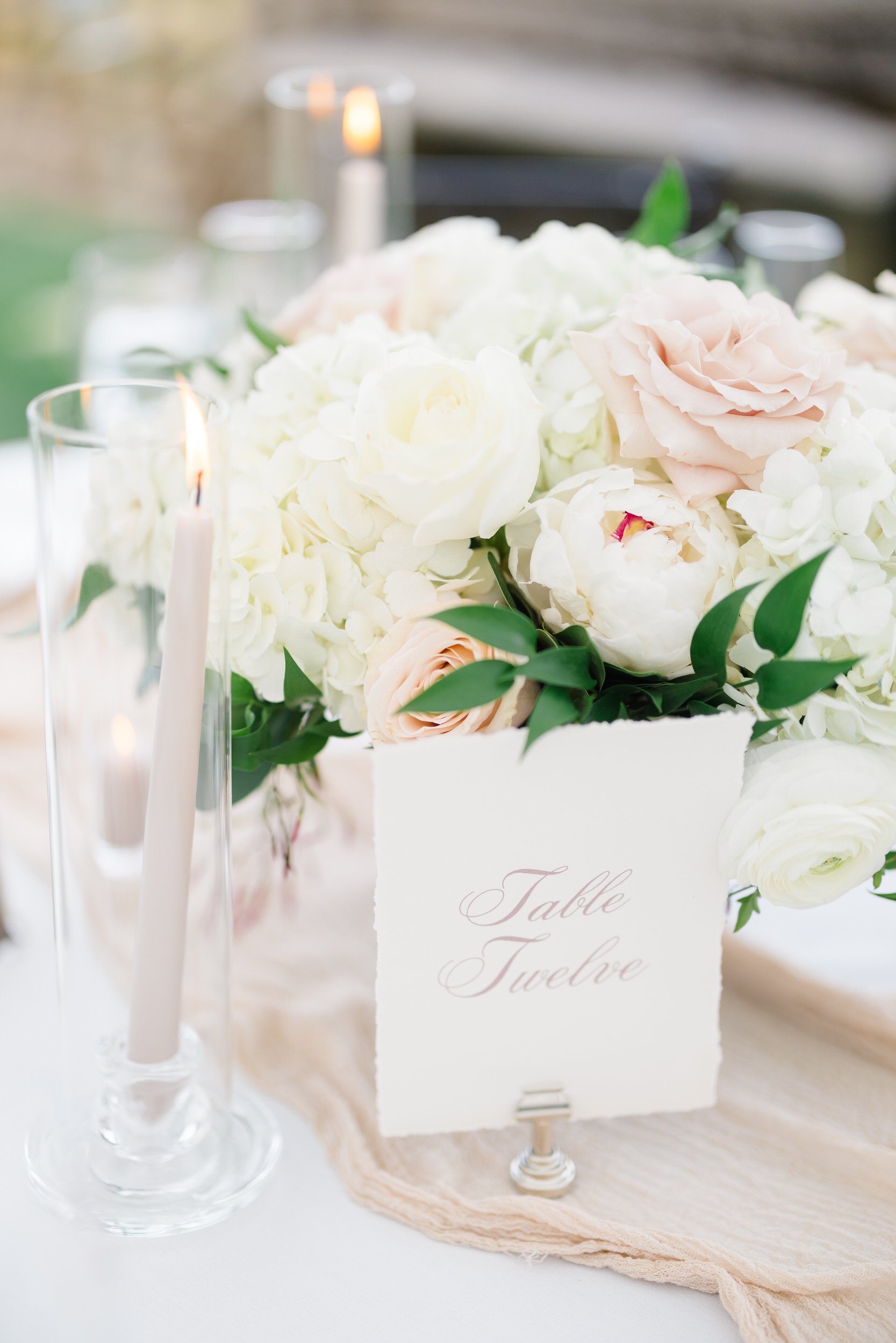 Wedding reception tables set inside the sailcloth tent overlooking the North Shore at Castle Hill.