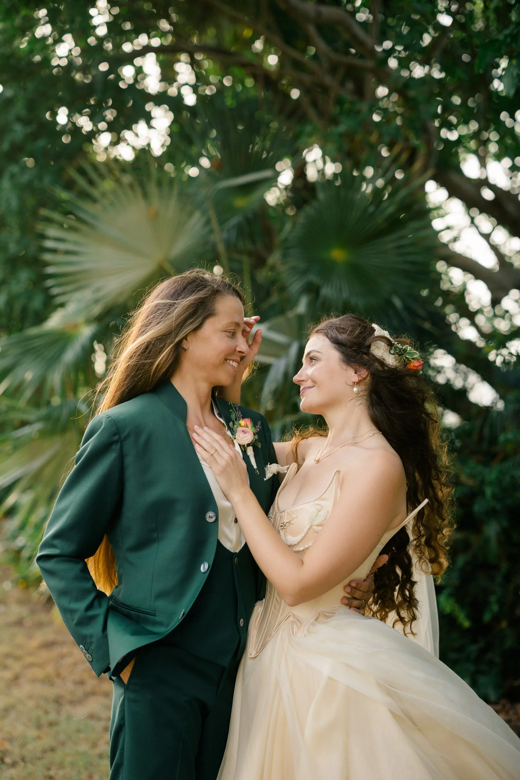 Handmade silk wedding gown and custom green suit in an editorial wedding portrait.