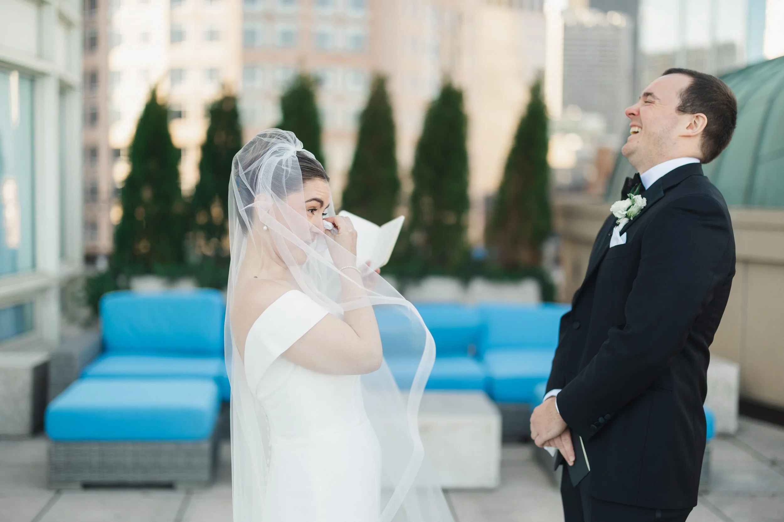 Couple sharing private vows on the Boston Harbor Hotel rooftop overlooking the water