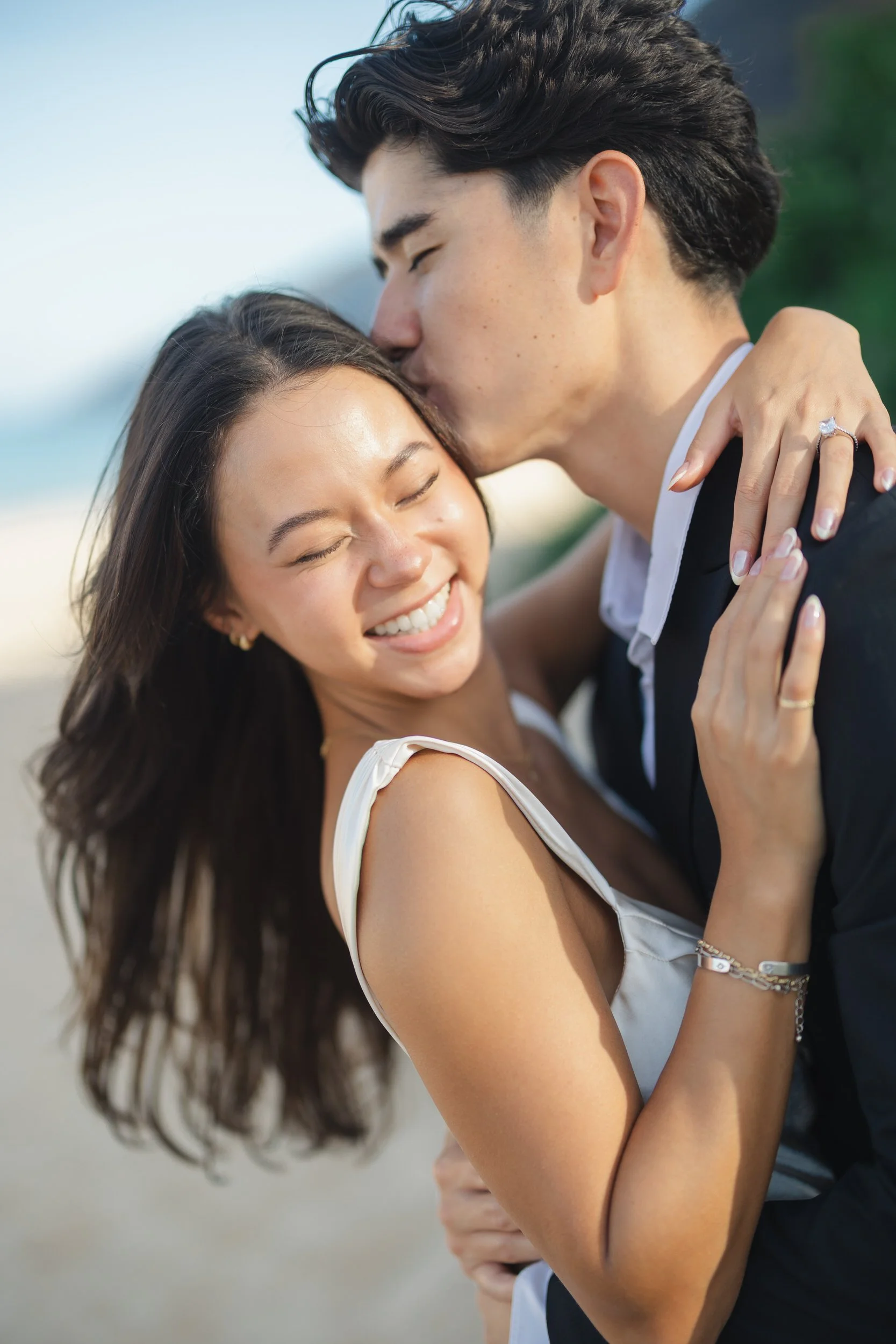 Romantic couple standing on beach during Oahu elopement at sunrise