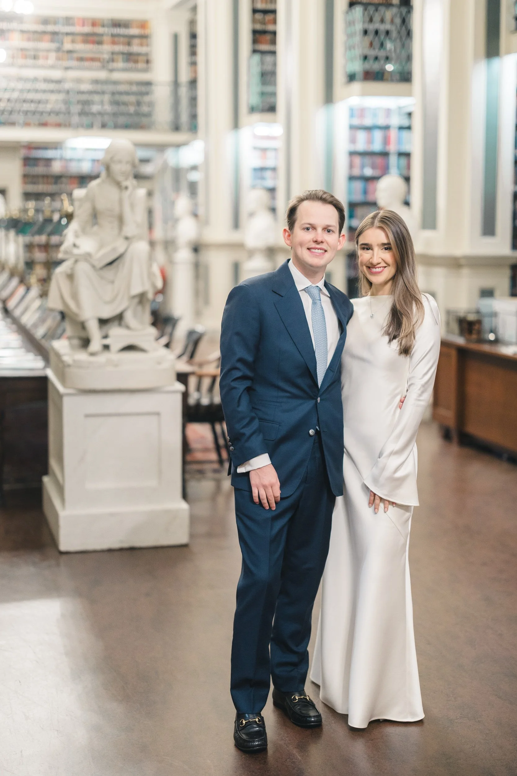 Couple portraits inside the Boston Athenaeum surrounded by classic books