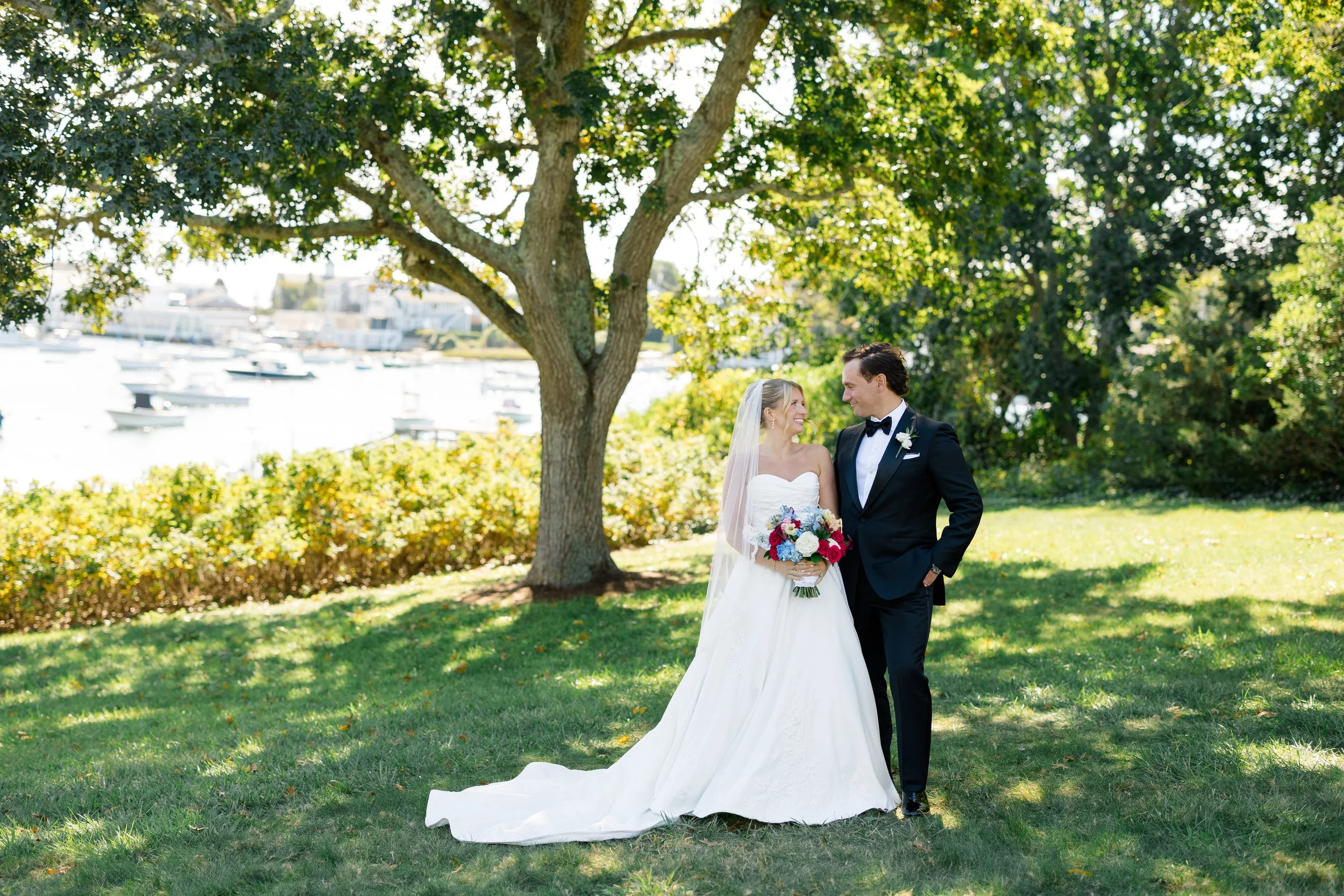 Wedding couple portraits overlooking Wychmere Harbor at Wychmere Beach Club on Cape Cod.