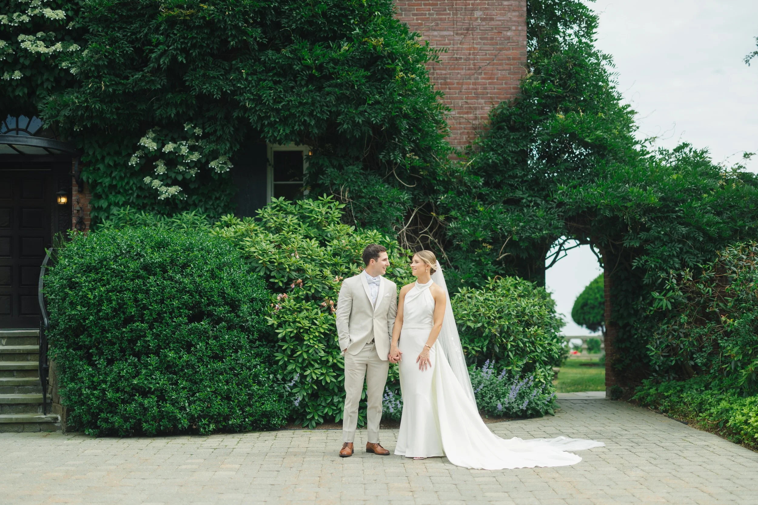 Elegant couple portraits at a coastal garden party wedding.
