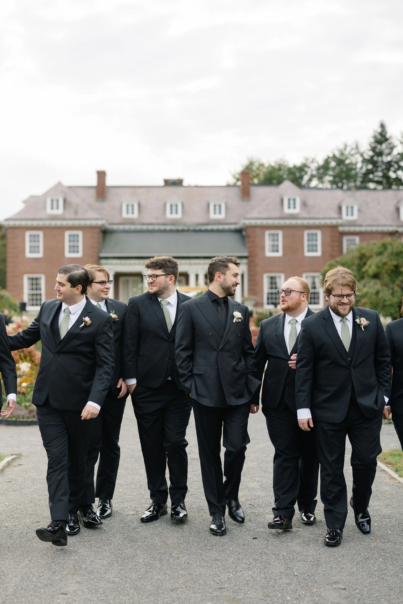 Groomsmen portraits at a secret garden inspired wedding in Massachusetts.