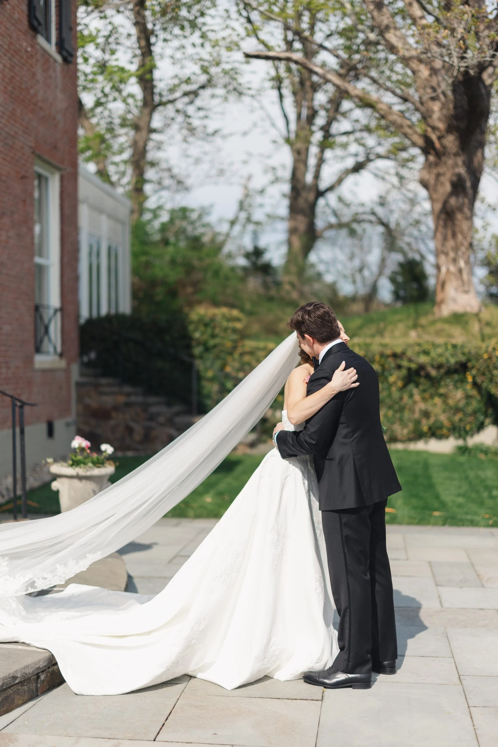 Documentary-style first look photography at oceanfront wedding venue