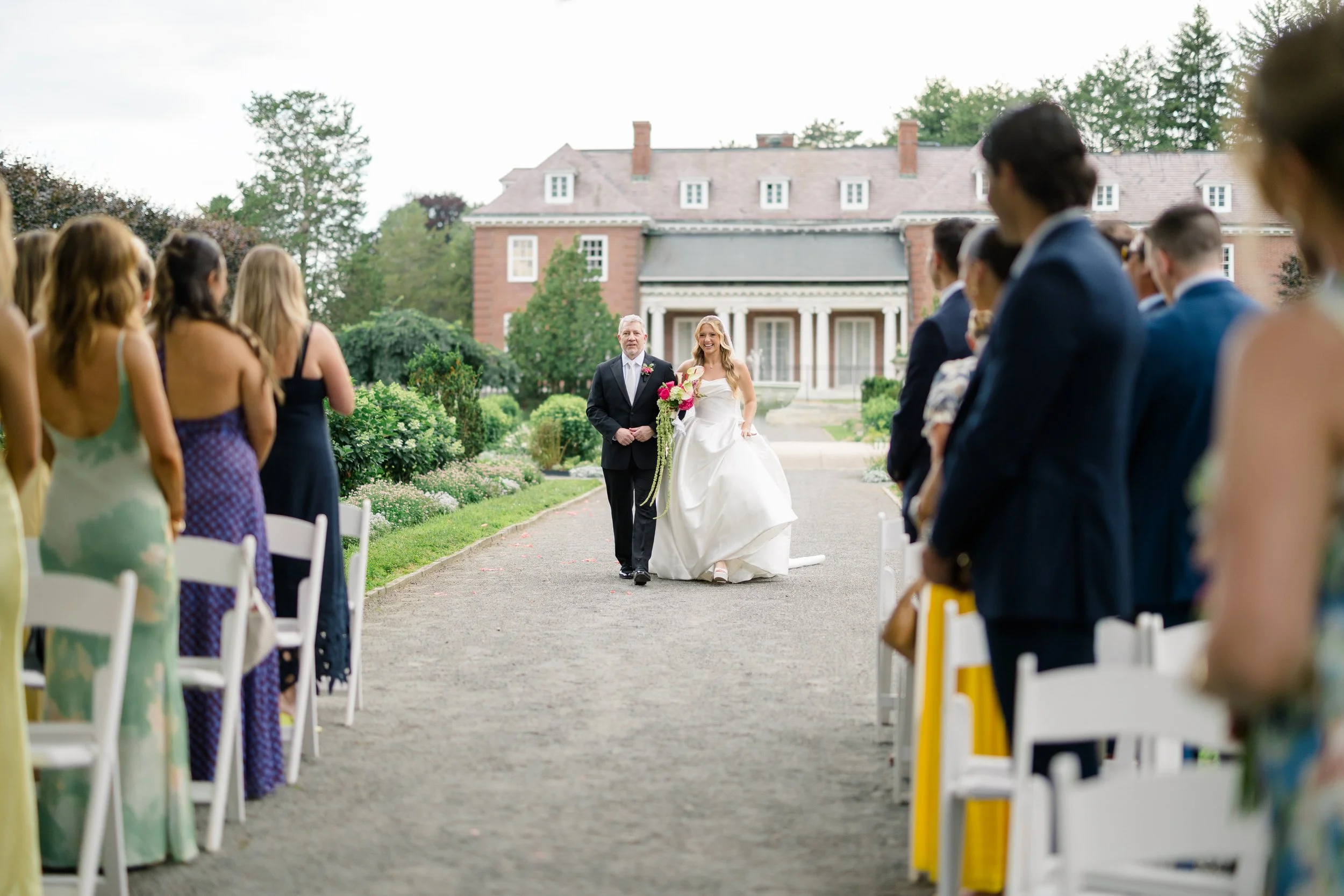 Bride walking down the aisle during an Elm Bank wedding ceremony