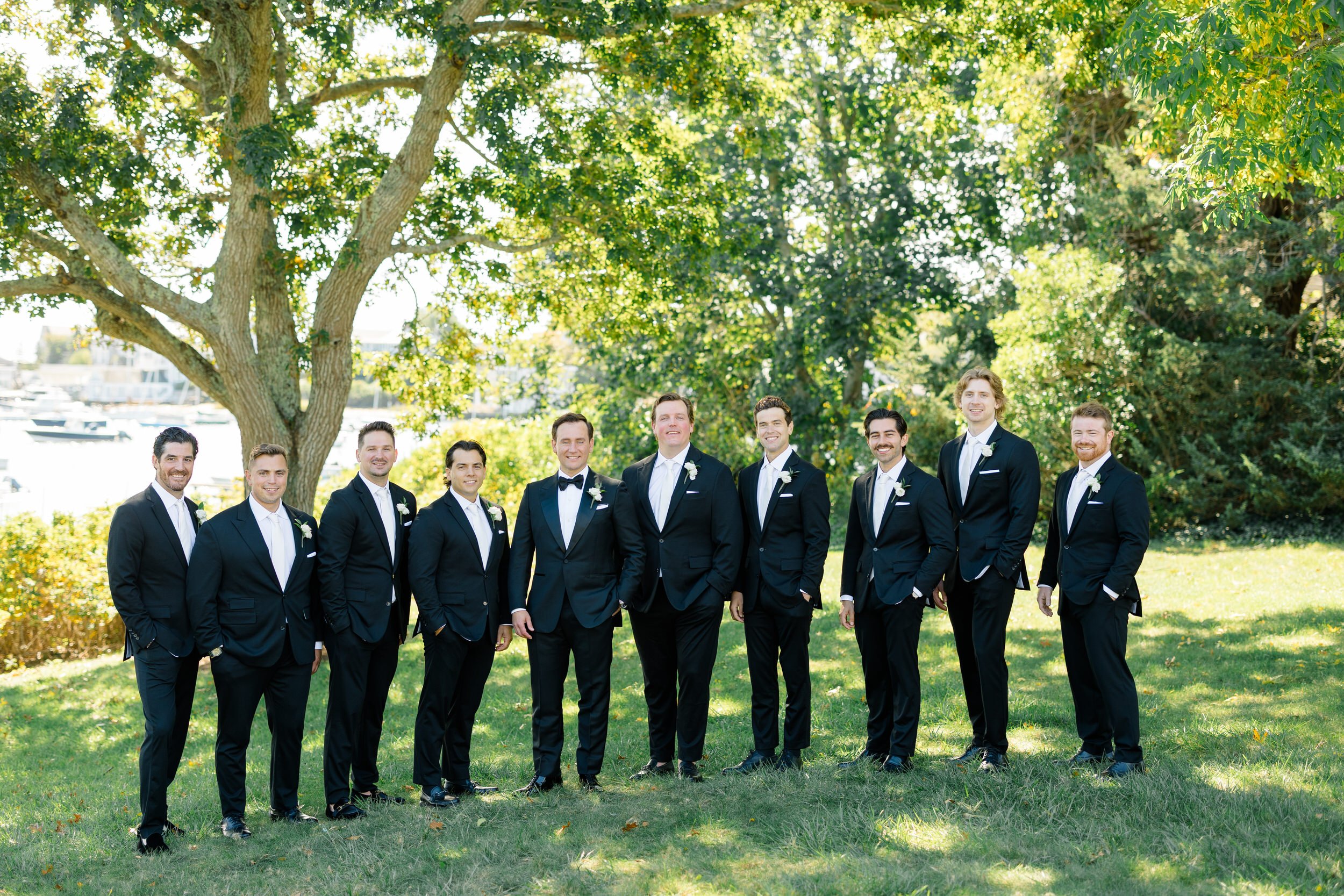 Groom posing with his groomsmen at a coastal Massachusetts wedding.