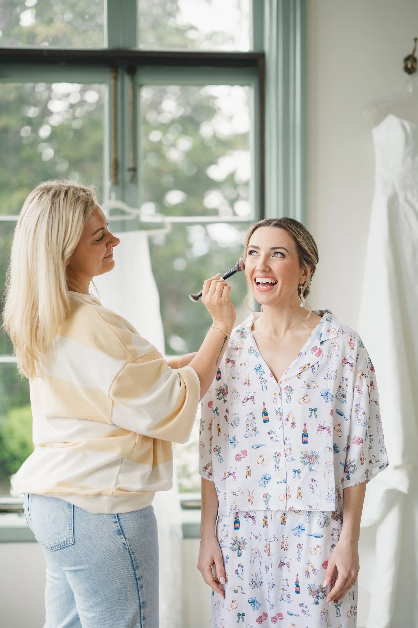 Bride getting ready in bright window-filled suite at Misselwood Estate