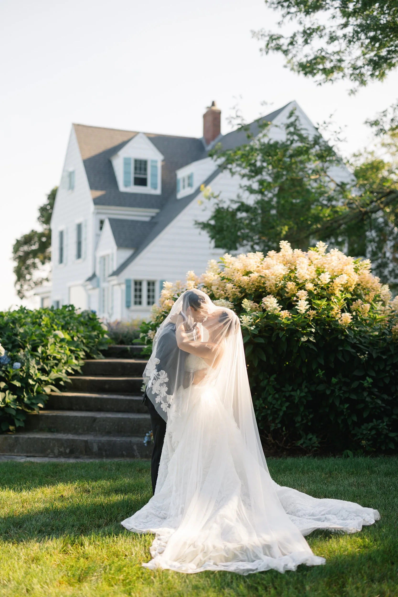 Timeless wedding portraits with blooming hydrangeas at a Cape Cod waterfront estate.