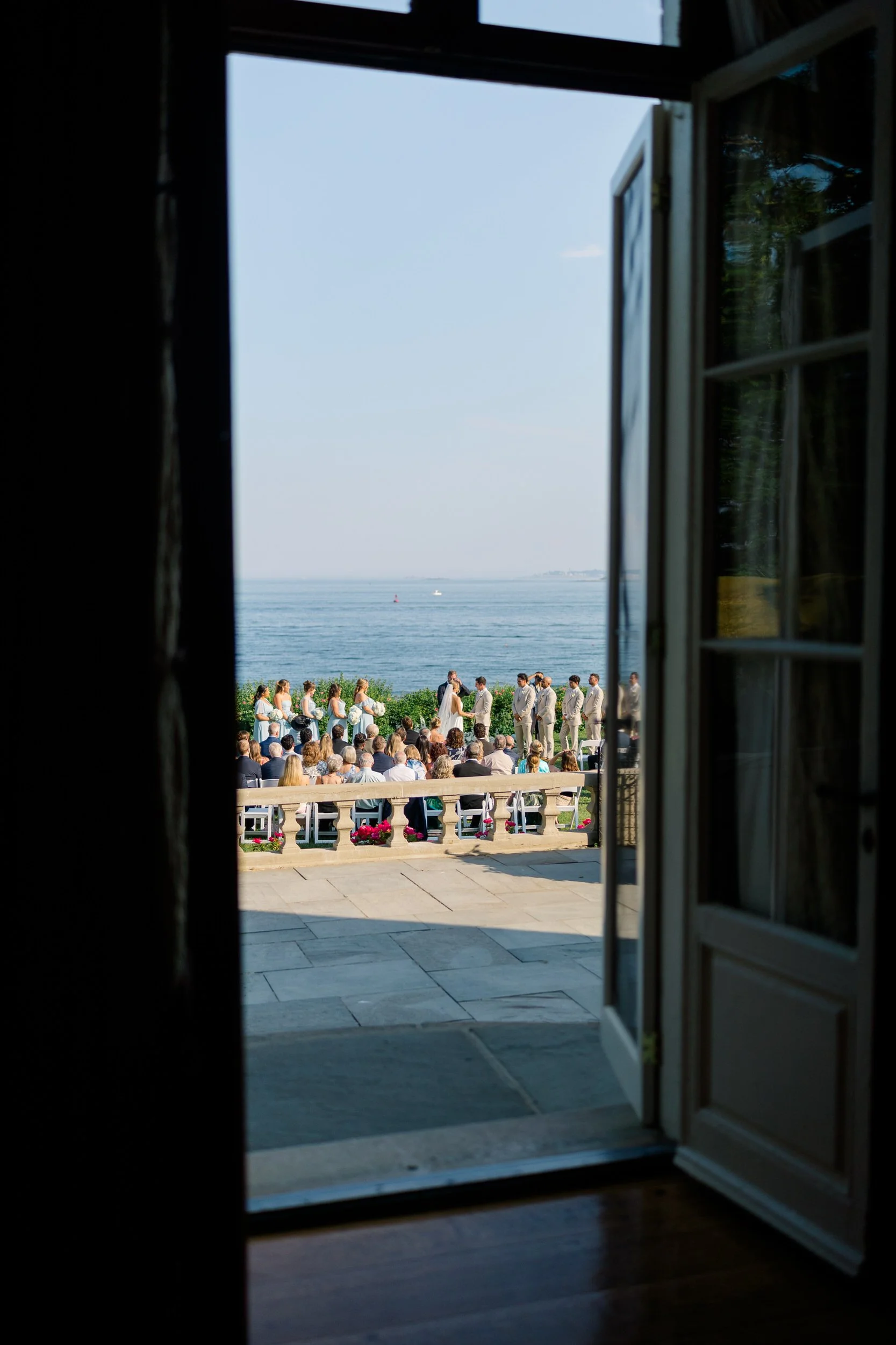 Summer wedding ceremony overlooking the ocean in Beverly, Massachusetts.