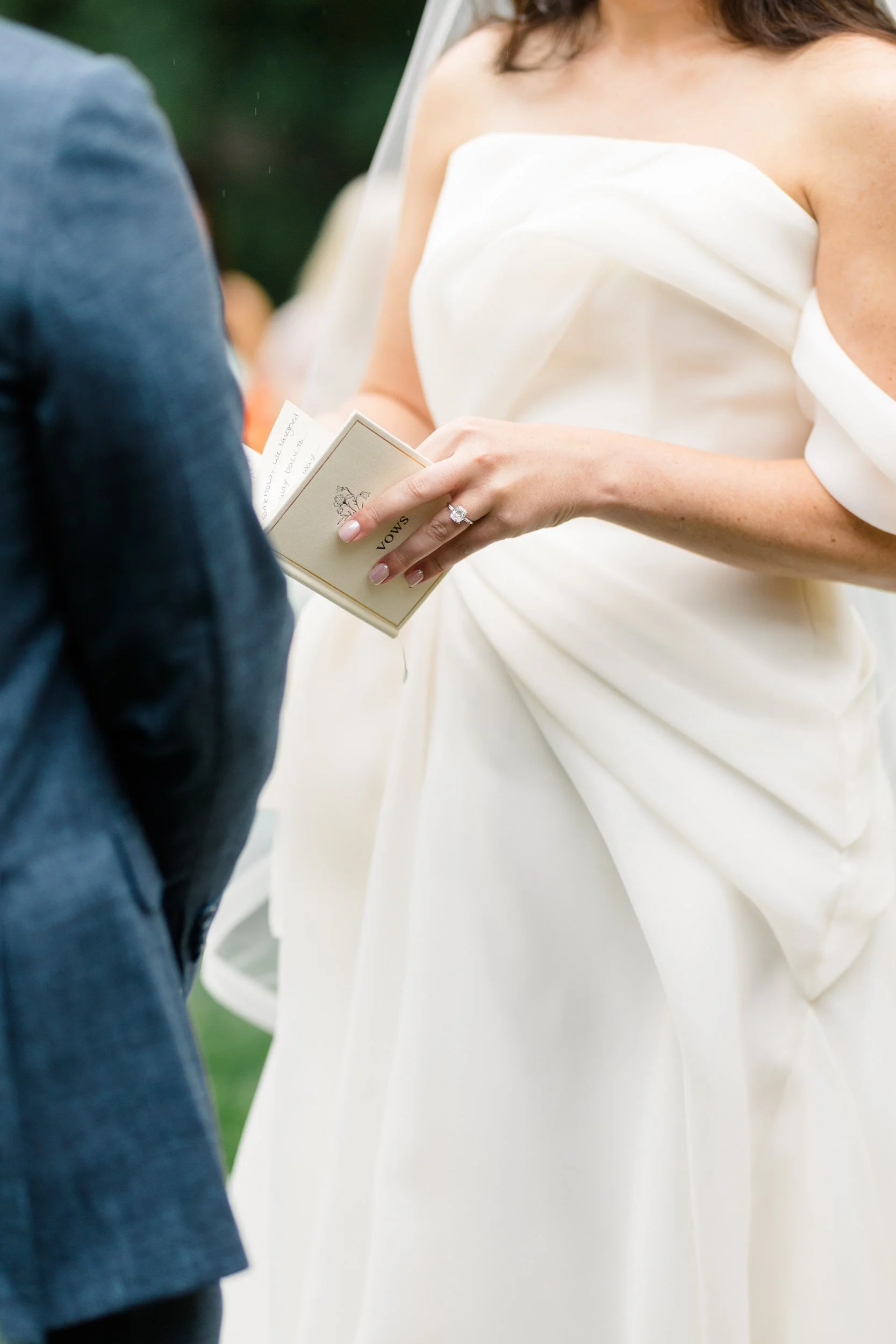 Bride and groom exchanging vows beneath a vibrant garden-inspired floral installation.