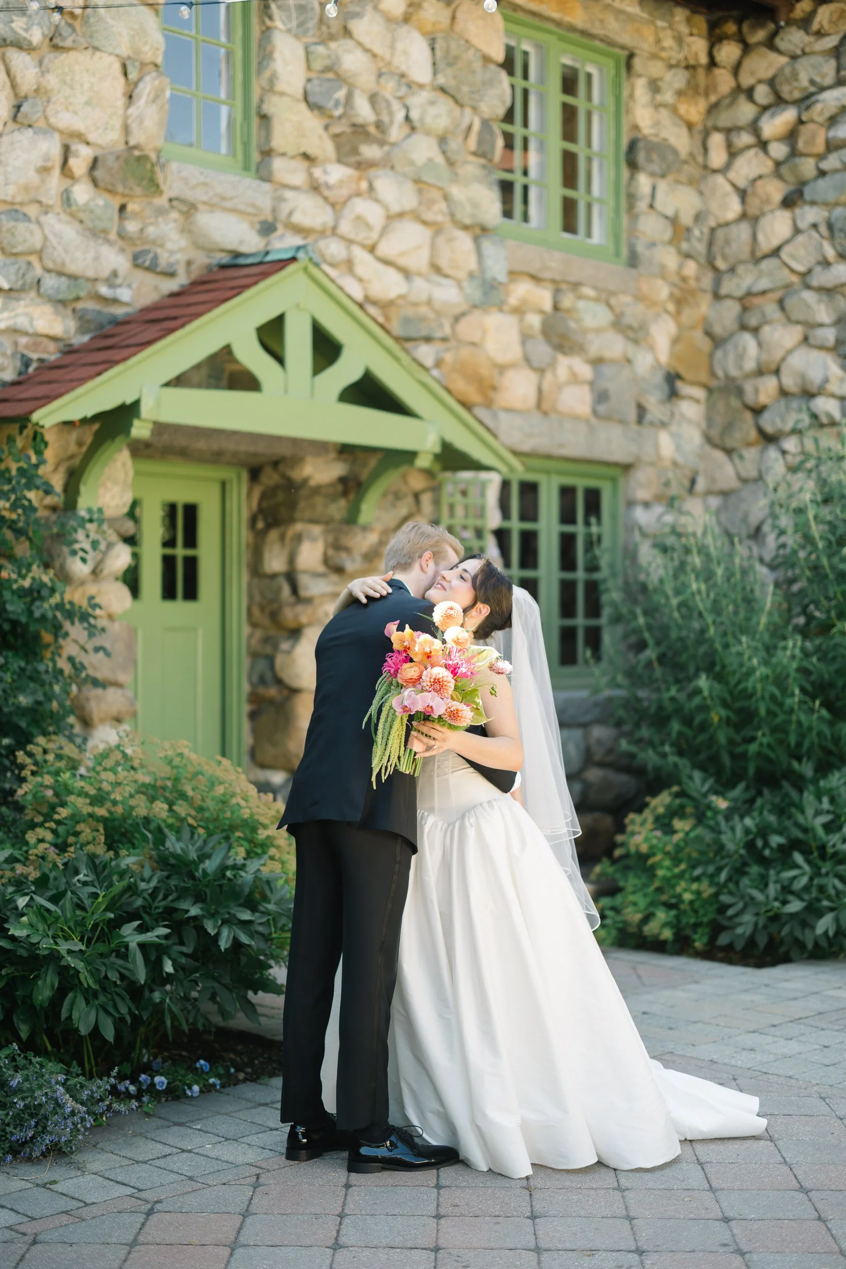 Romantic first look moment in lush garden setting at Massachusetts estate wedding venue
