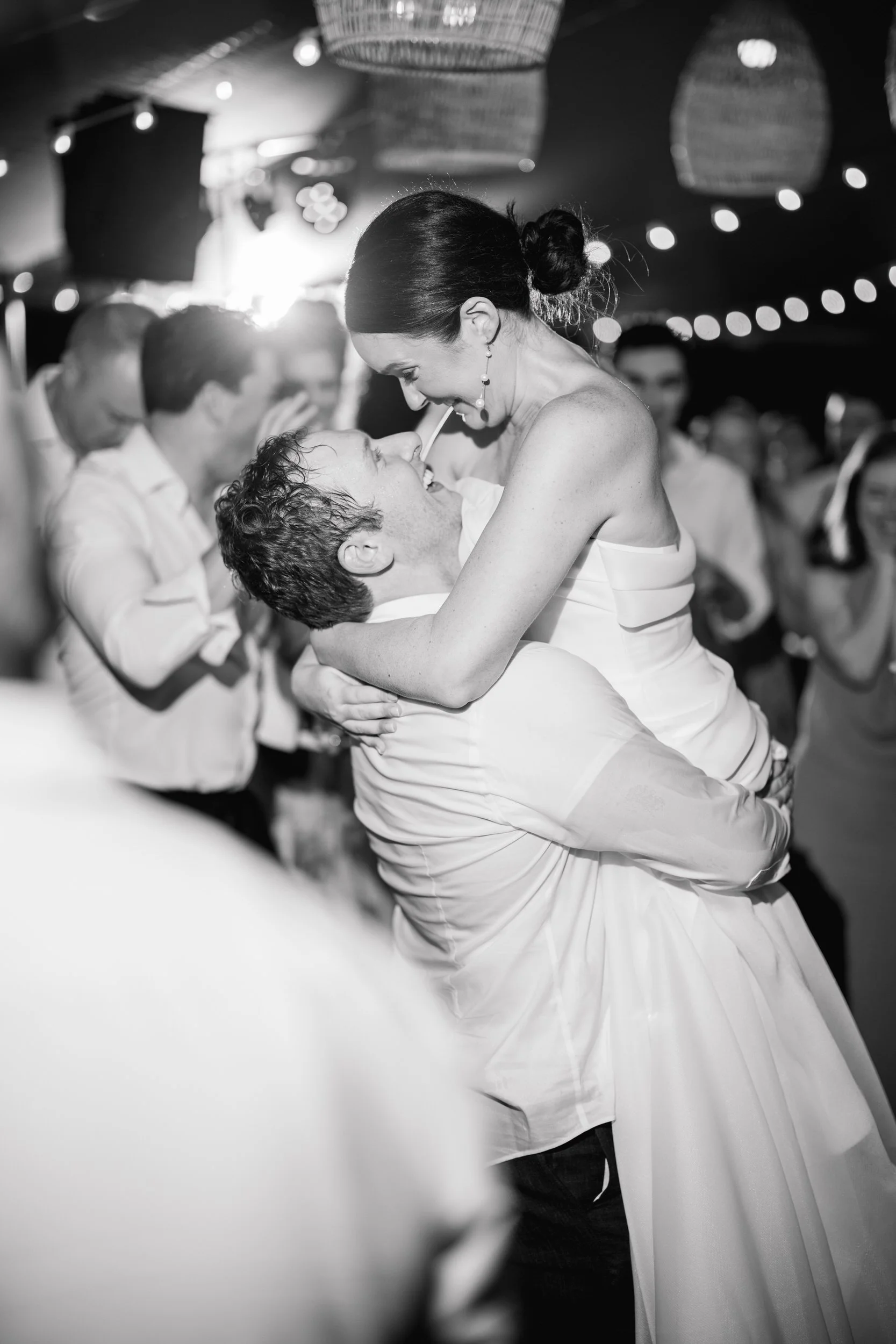 Whimsical colorful wedding reception filled with lush flowers and joyful dancing.