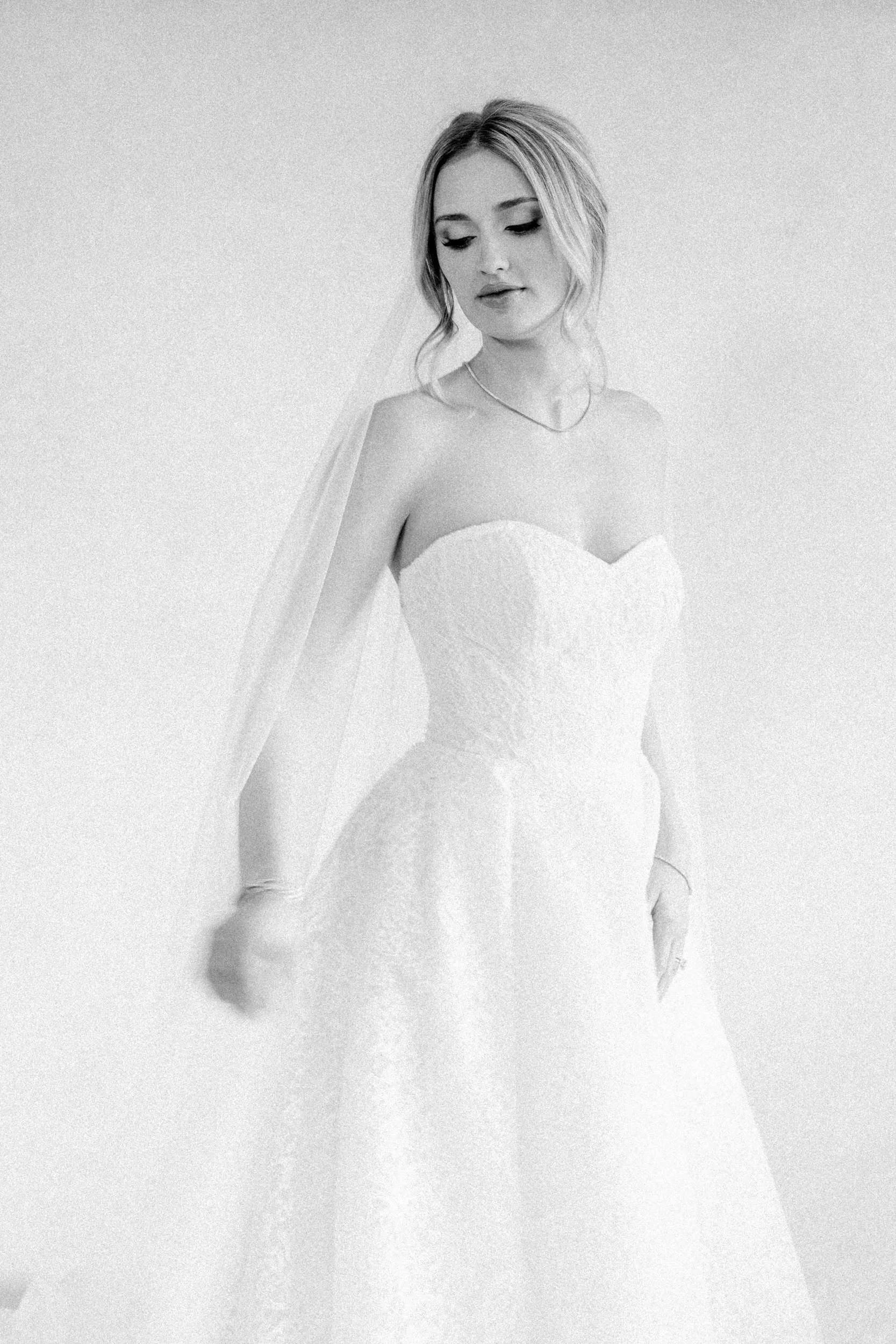 Bride in natural light with a blush pink backdrop during wedding morning at The Gadsen House