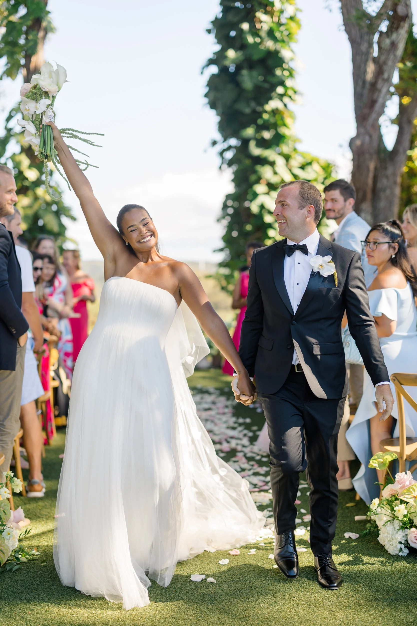 just married couple walking down the aisle at sunset ranch