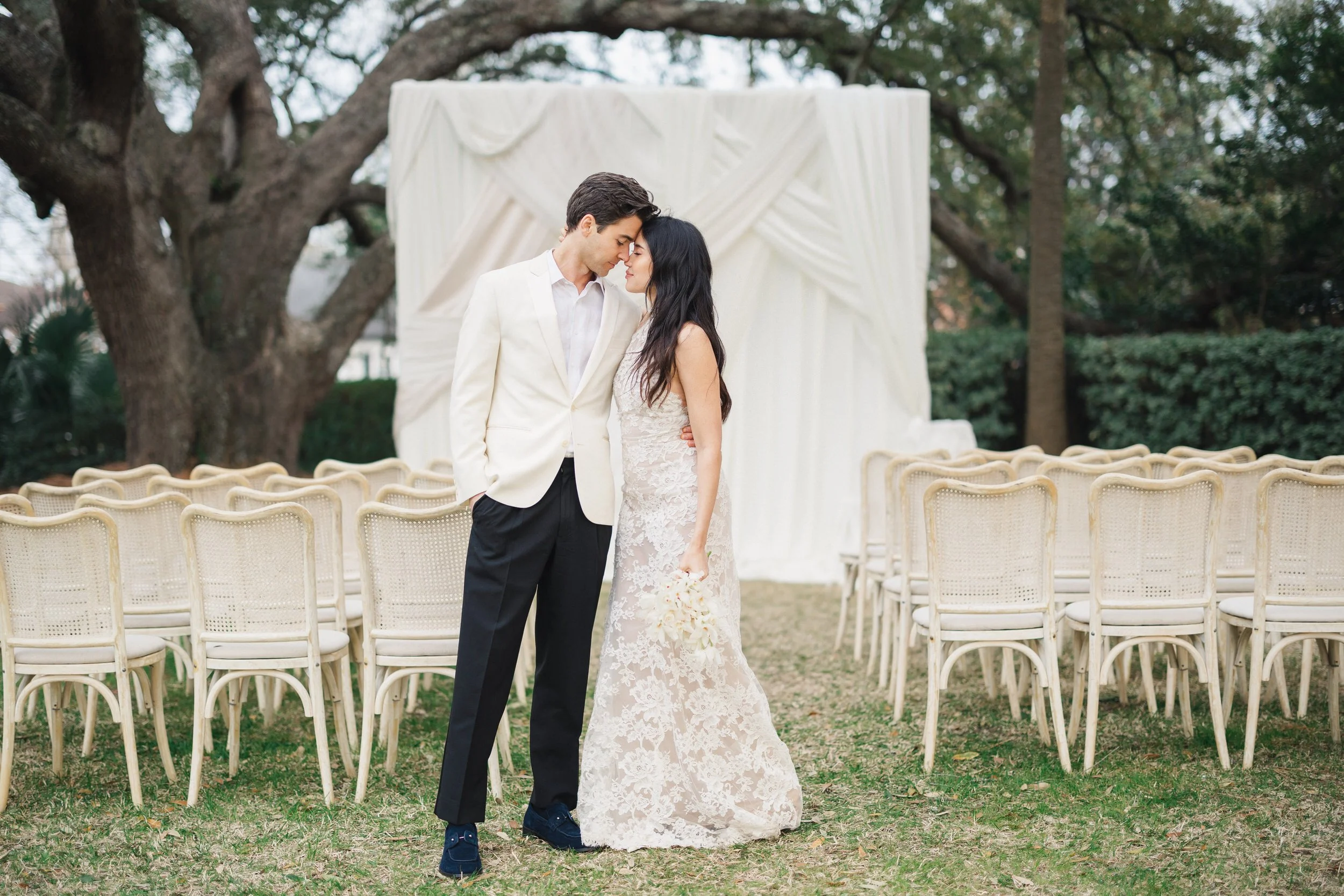 Elegant Lowndes Grove wedding portraits with ceremony florals and drapery