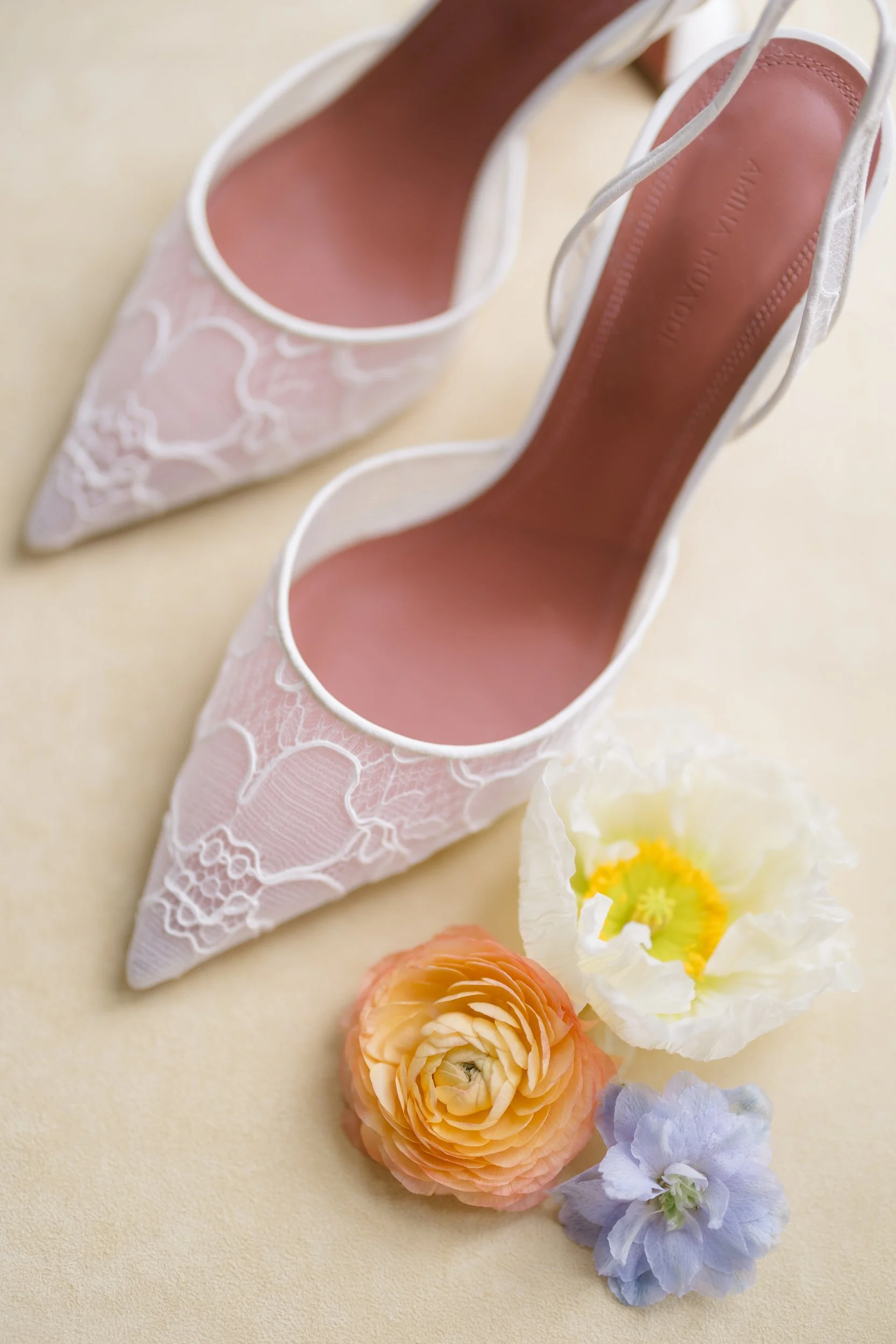 Bridal accessories styled with colorful dahlias, English roses, and whimsical garden-inspired details.