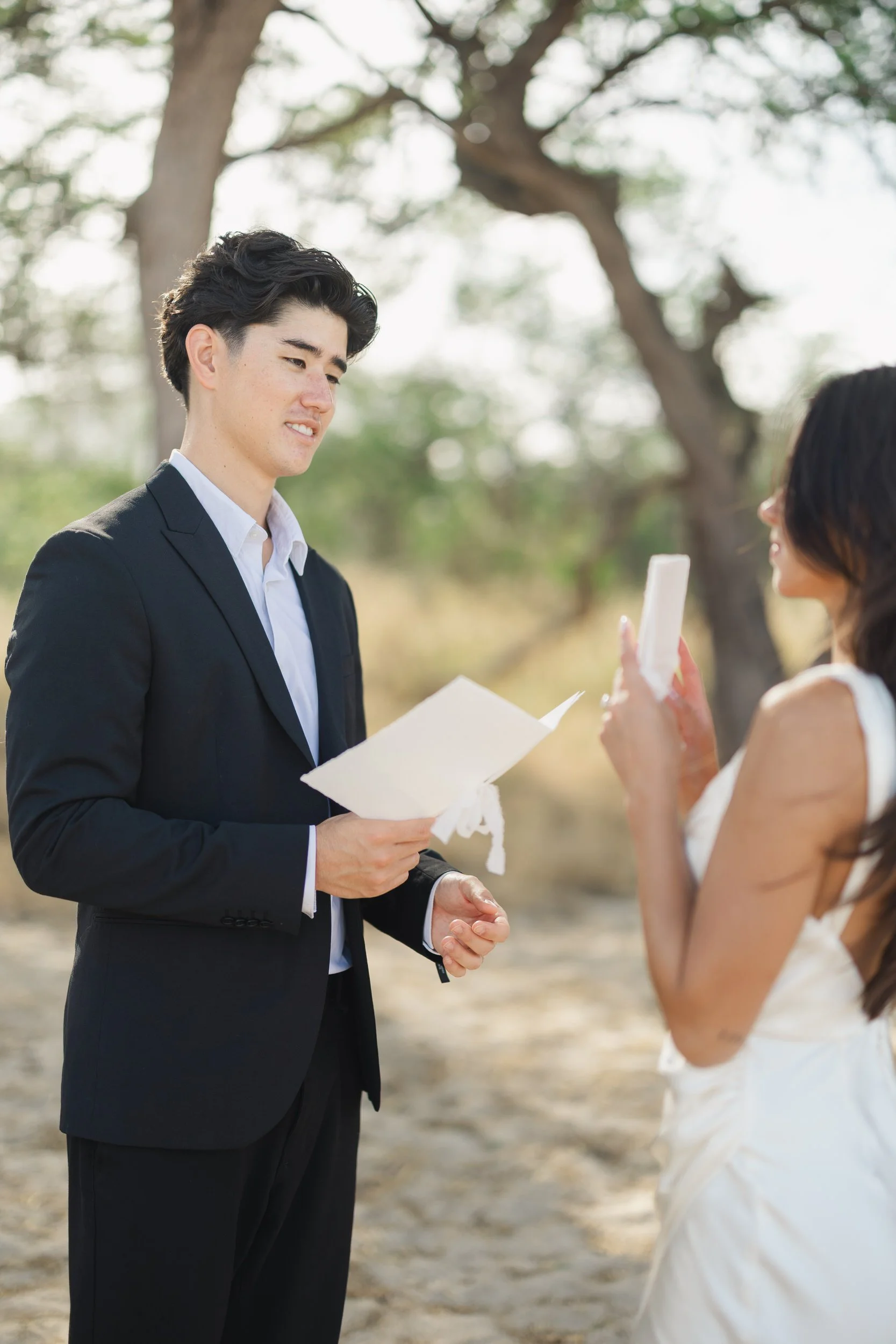 Intimate vow exchange on Oahu beach at sunrise ceremony