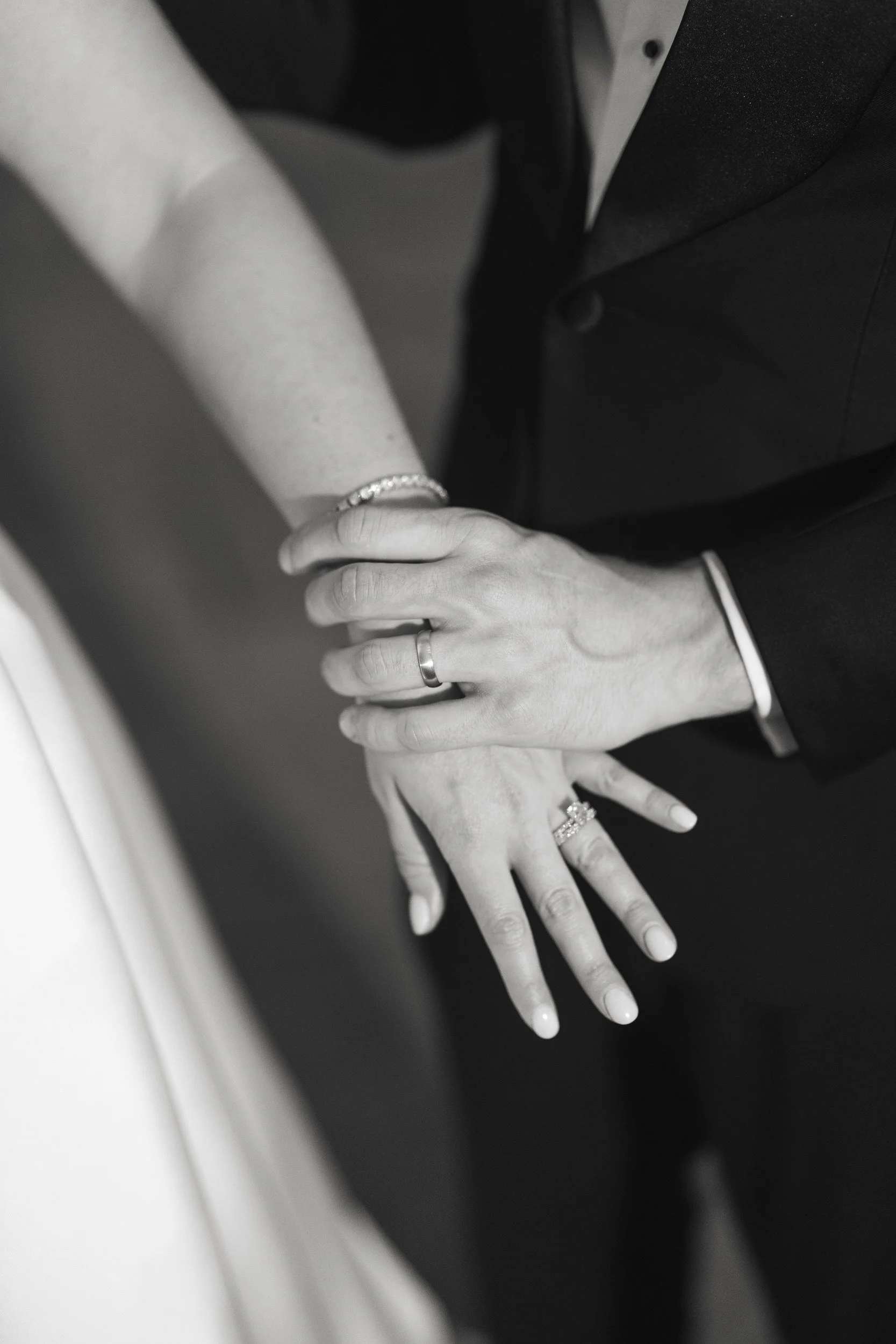 Bride in her Monique Lhuillier gown and groom sharing a quiet moment during sunset at Crane Estate.