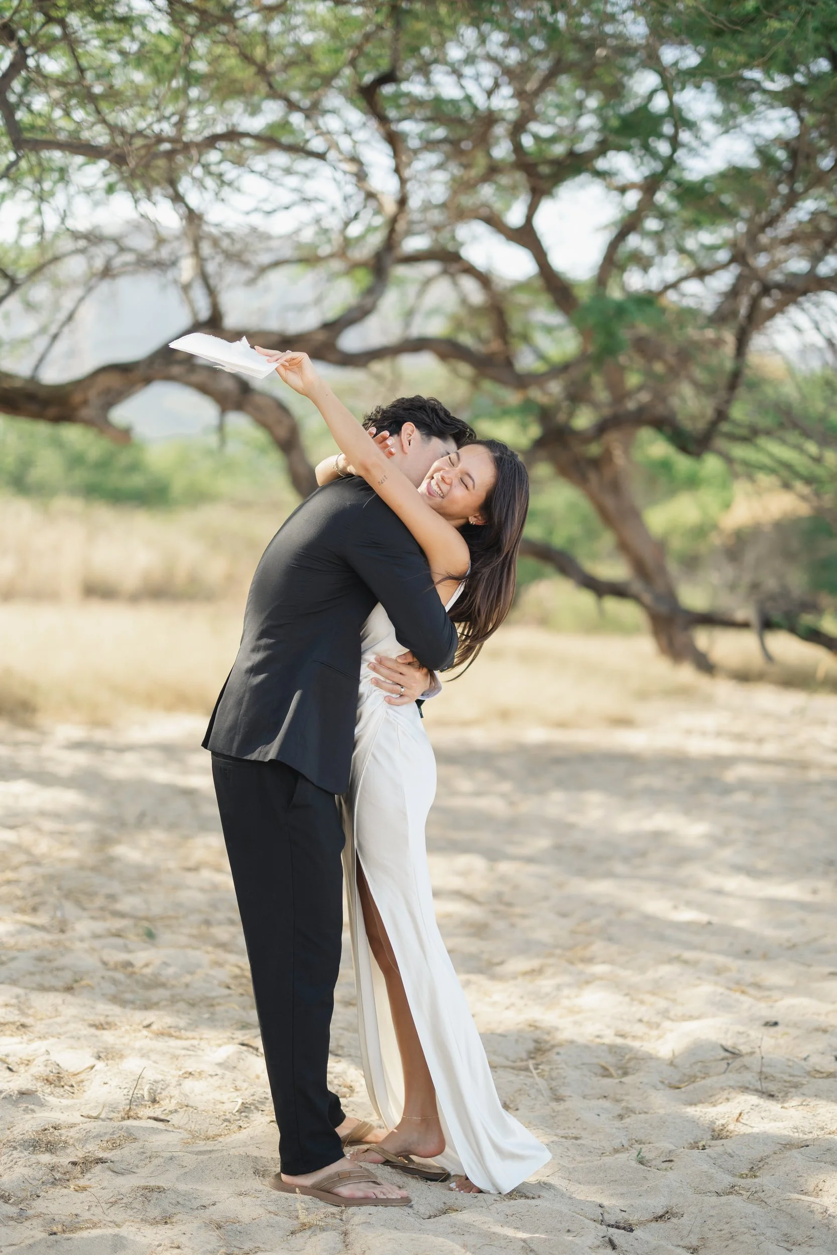 Couple exchanging vows during sunrise beach elopement in Oahu