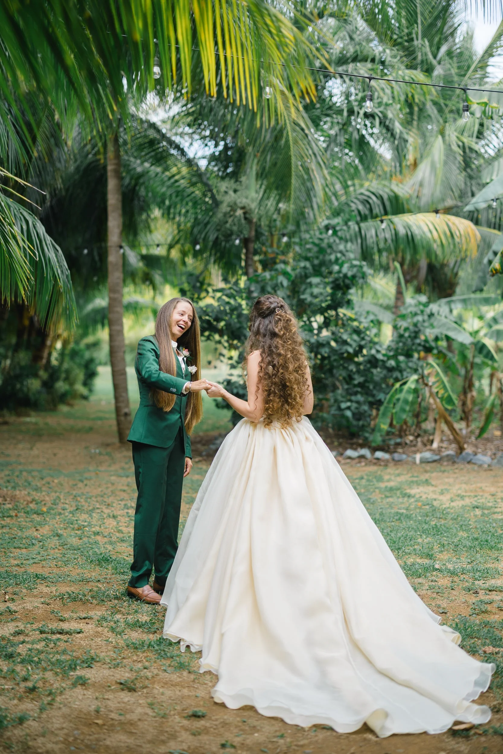First look at a destination wedding surrounded by lush tropical greenery.