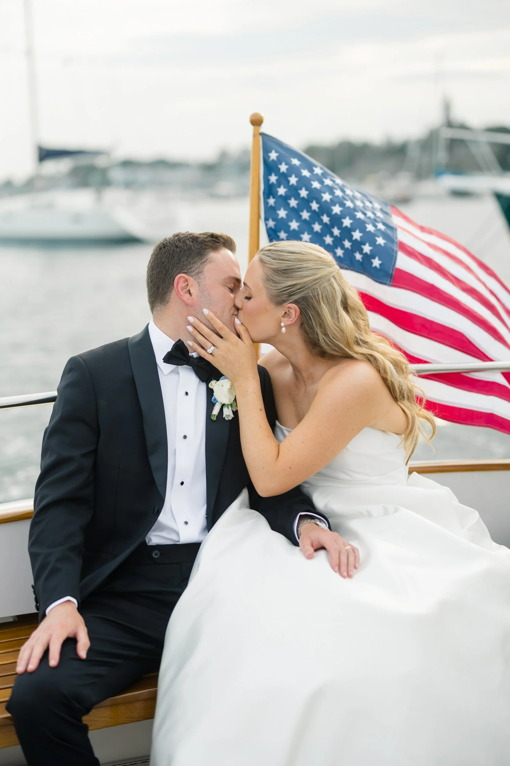 Elegant waterfront wedding portraits taken on a boat during a Corinthian Yacht Club Marblehead Massachusetts wedding.