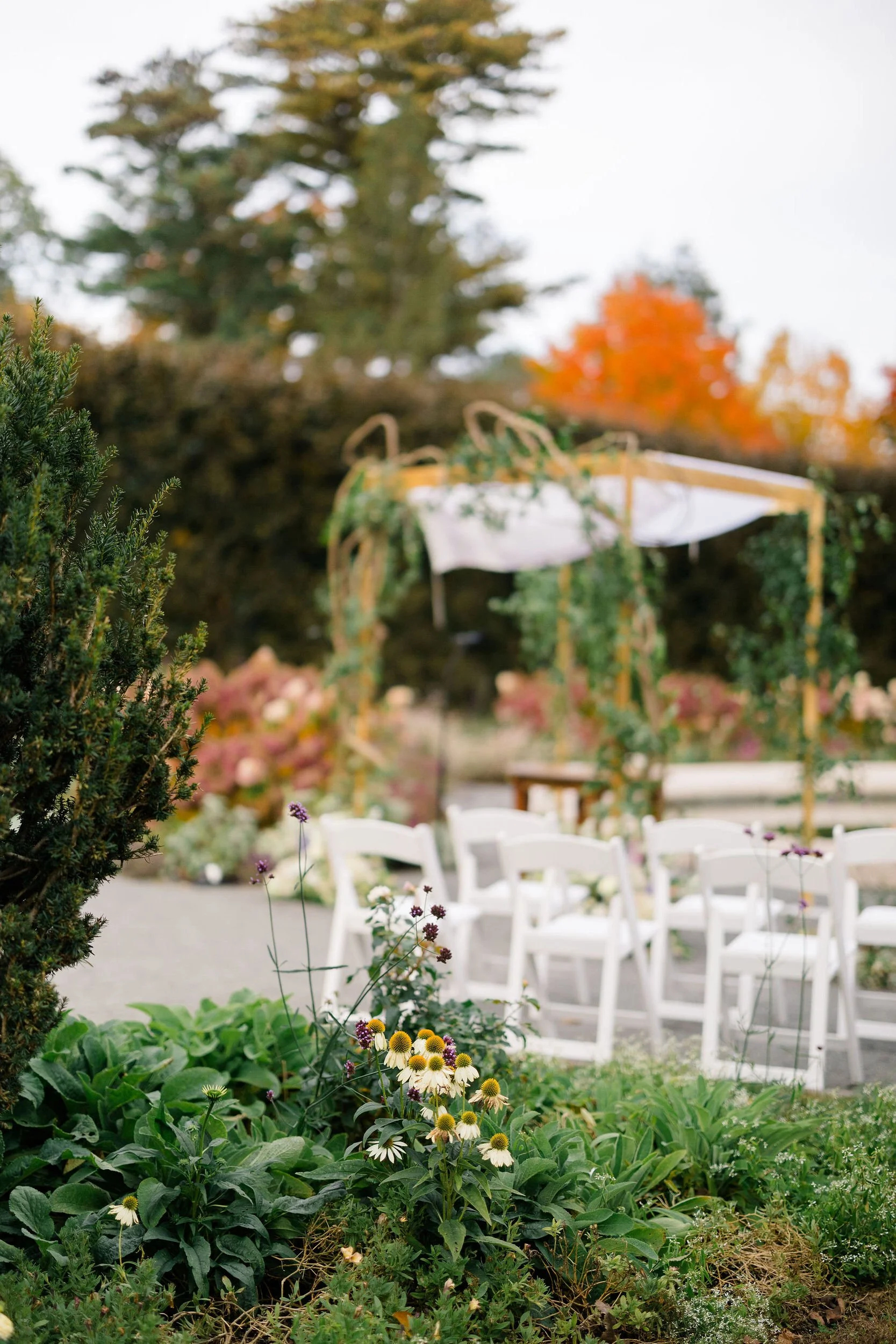 Floral arrangements and ceremony styling for a romantic secret garden wedding.
