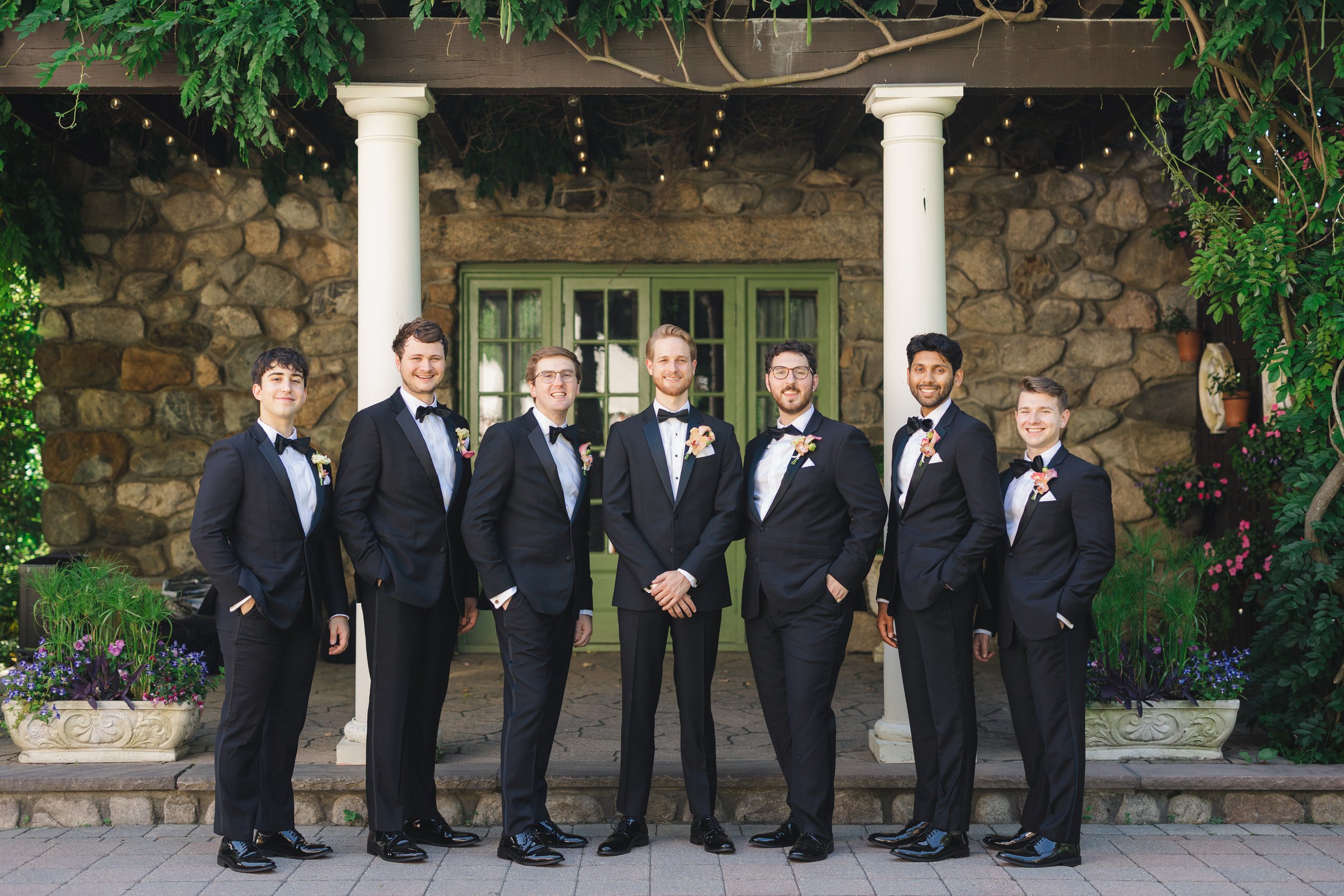 Classic groomsmen portraits in historic estate garden setting in Topsfield MA